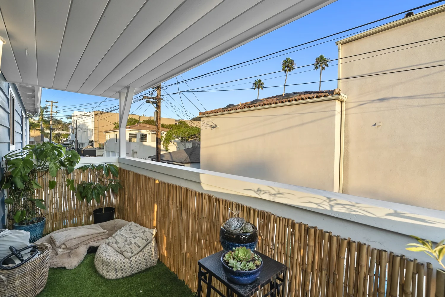 Covered balcony with artificial turf and bamboo screening