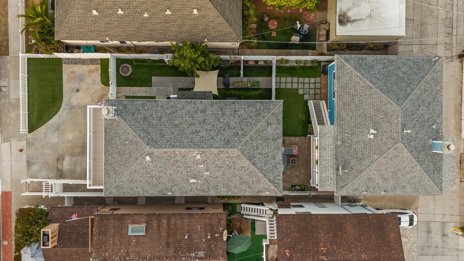 Overhead drone view of both roofs, the yards and the alley