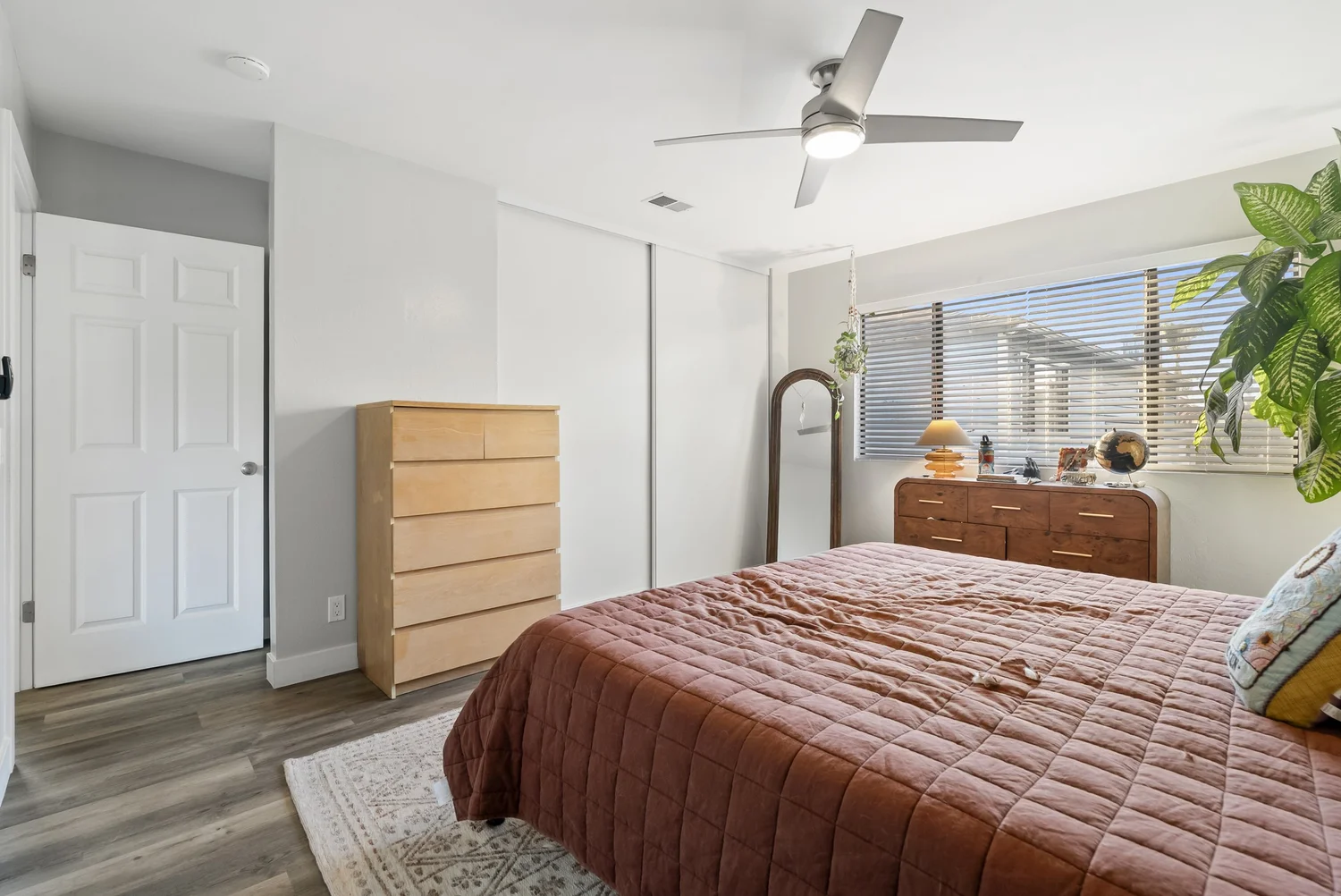 Bedroom with dresser and ceiling fan