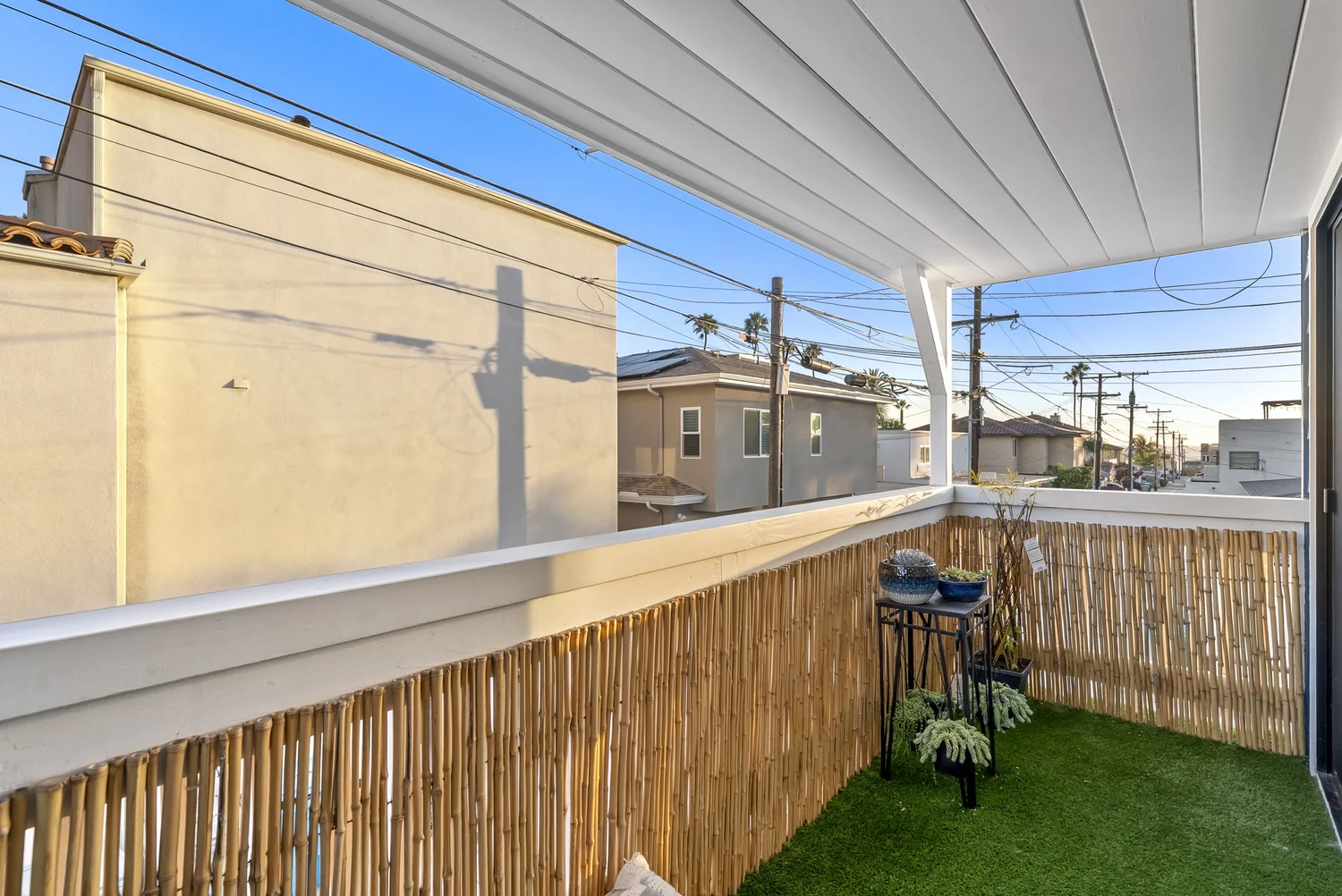 Covered balcony with turf and neighborhood view