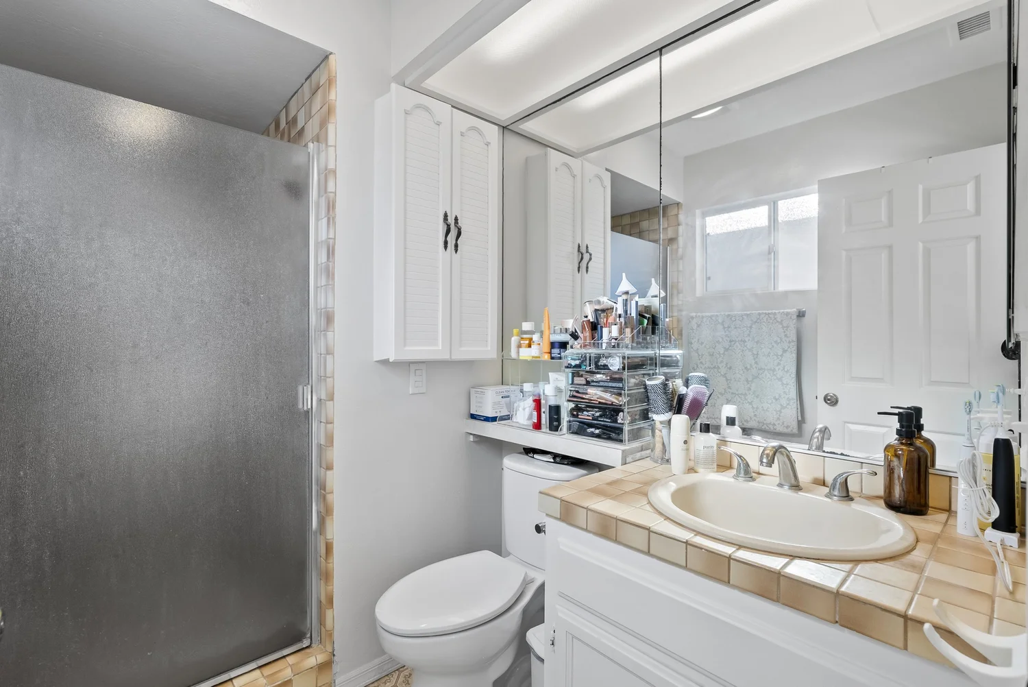 Bathroom with walk-in shower and tiled vanity