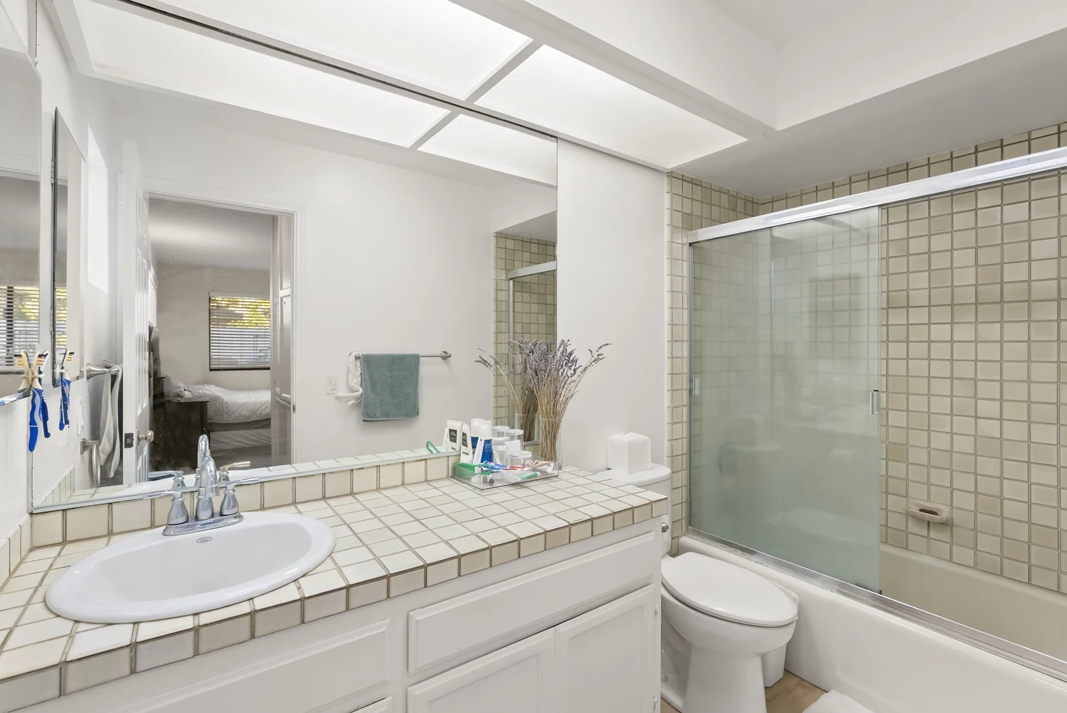Bathroom with tub and shower and tiled vanity