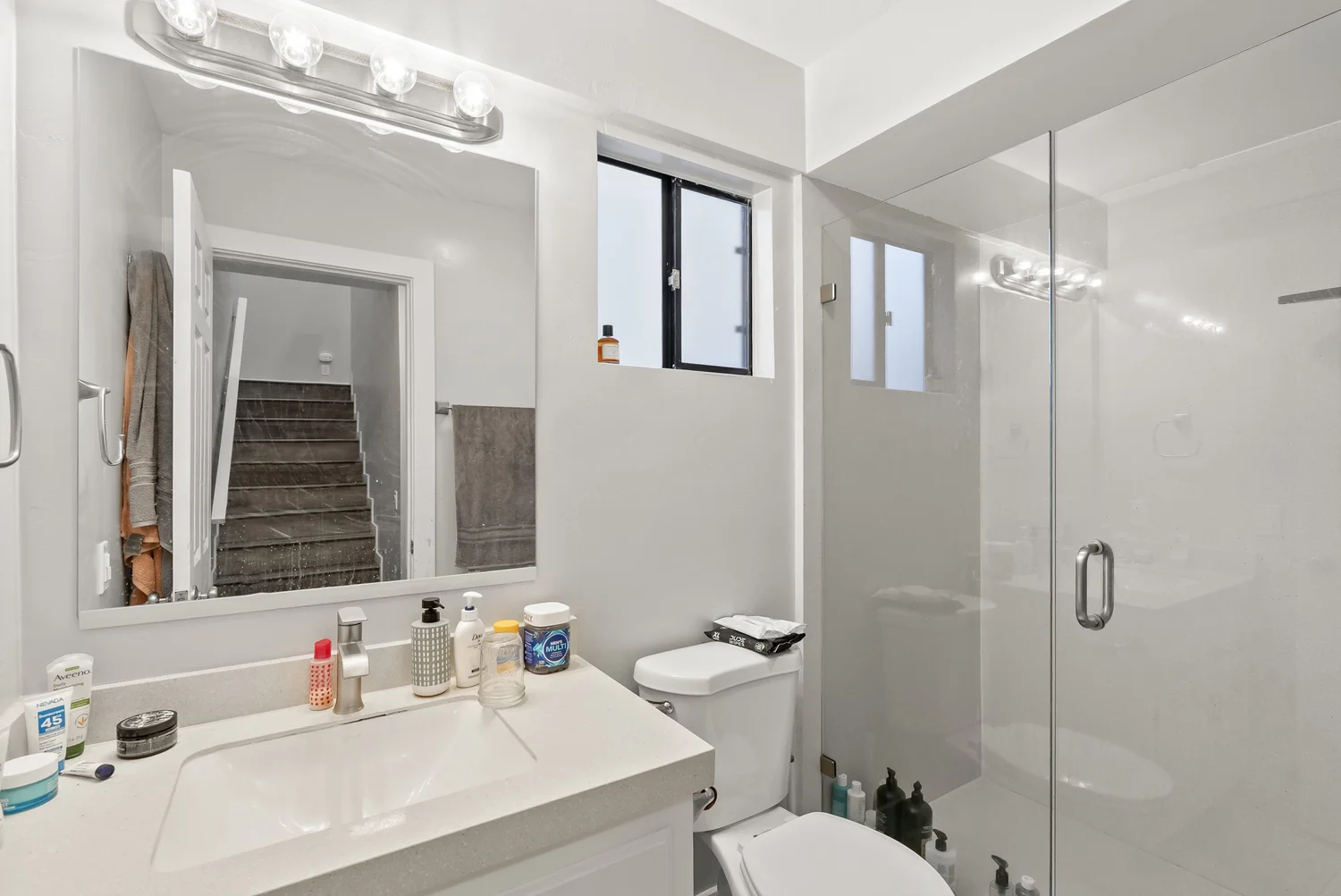 Bathroom with glass walk-in shower and vanity