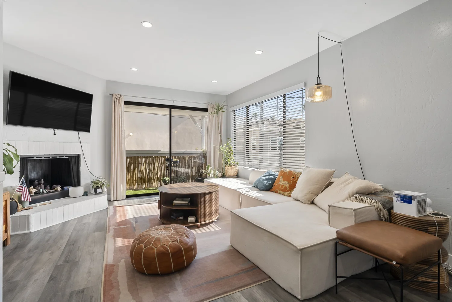 Rear home living room with fireplace, TV and sliding door