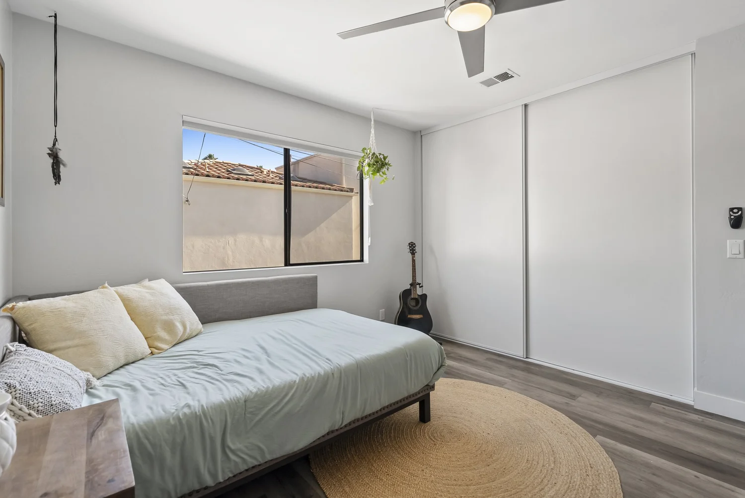 Bedroom with bed, sliding closet and window