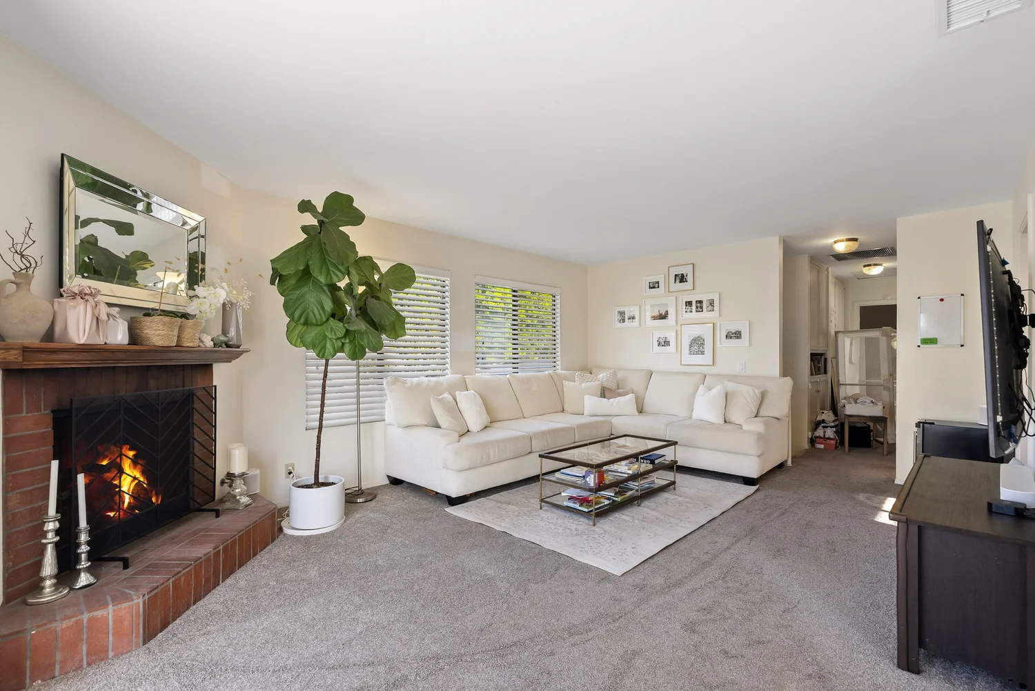 Living room with brick fireplace and sectional sofa