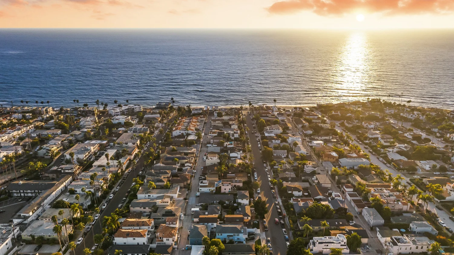 Sunset aerial over La Jolla's Barber Tract, between the Village and Windansea, with the Pacific on the horizon