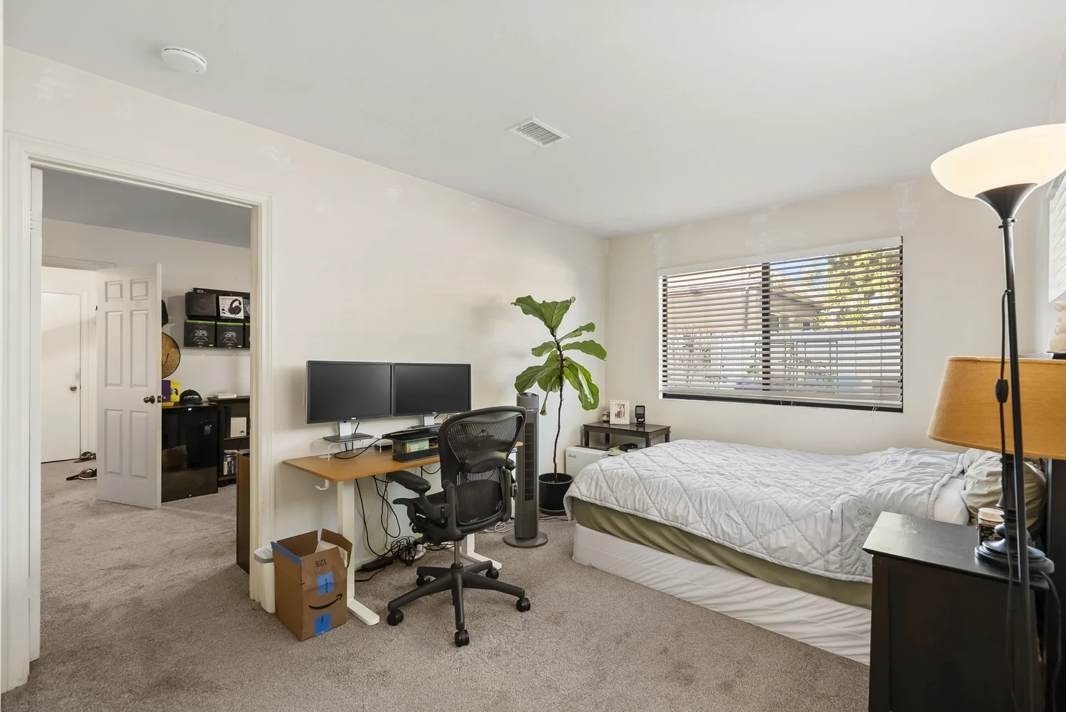 Bedroom with bed, desk and window