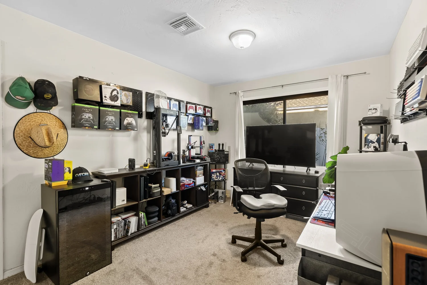 Bedroom set up as a studio with shelving and desk