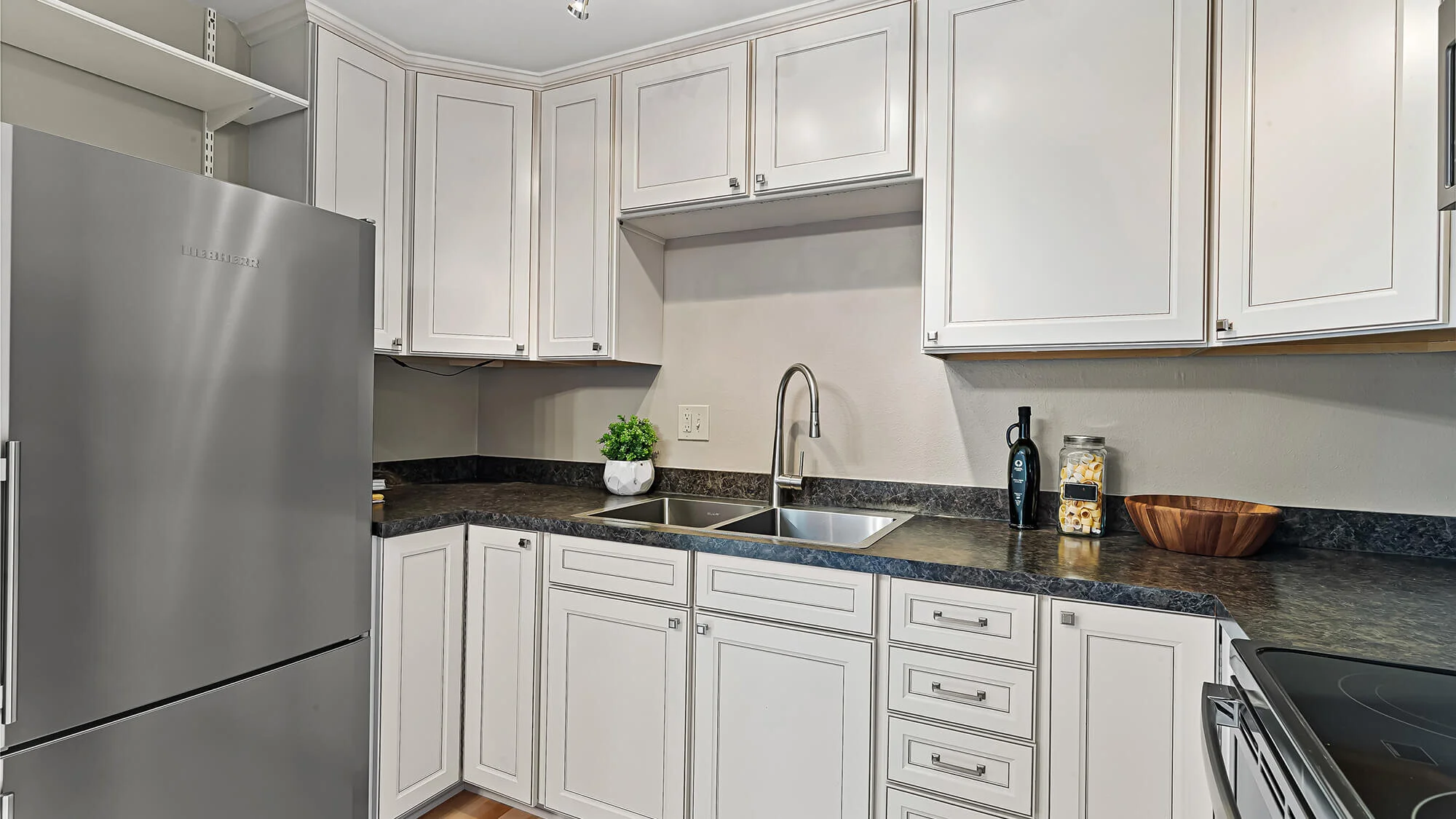 interior of kitchen with hardwood floors and cabinet space