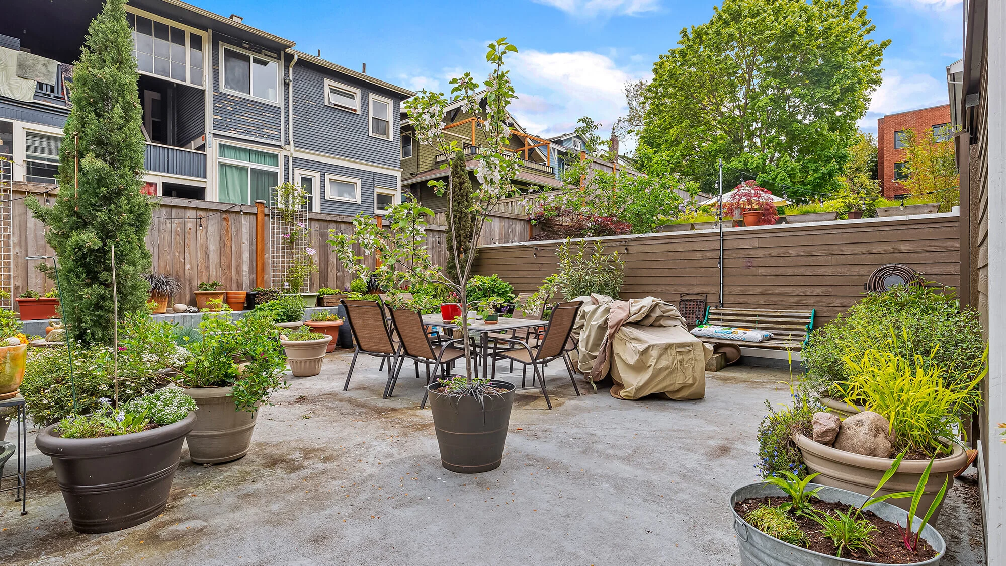 view of patio with dining furniture and plants