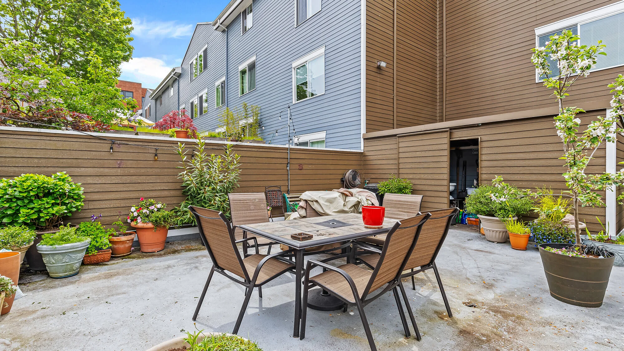 view of patio with dining furniture and plants