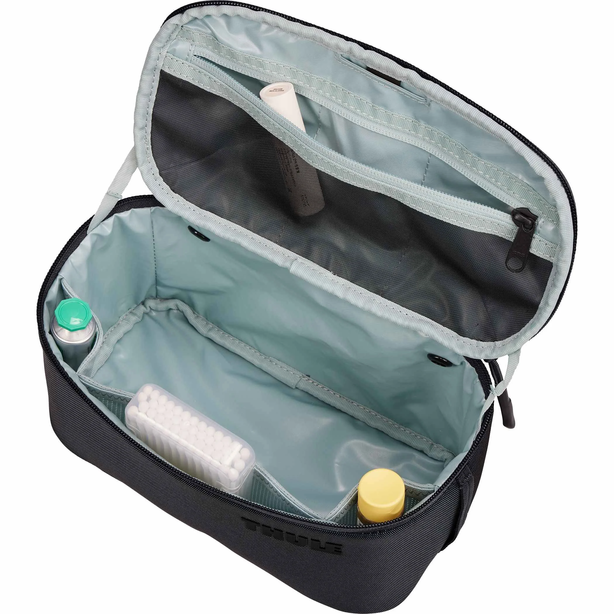 Top-down view of an open Thule Subterra 2 toiletry bag showing the lined interior compartments