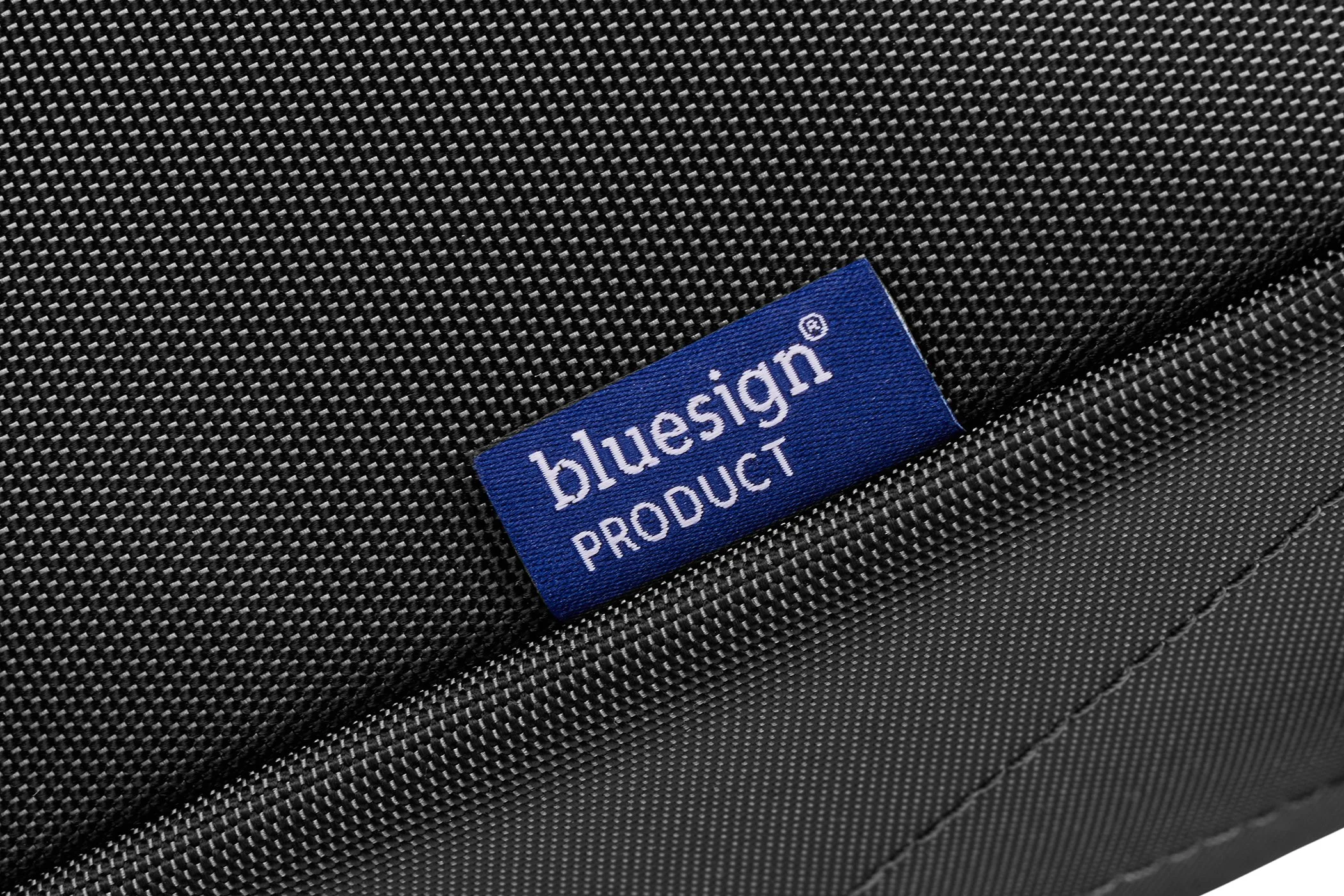 Close-up of the bluesign product label stitched onto black Thule fabric