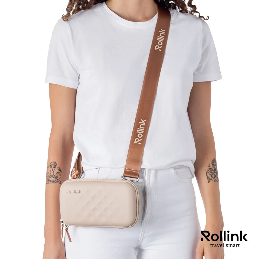 Woman wearing a beige Rollink Tour Mini Bag crossbody with a white t-shirt and white pants