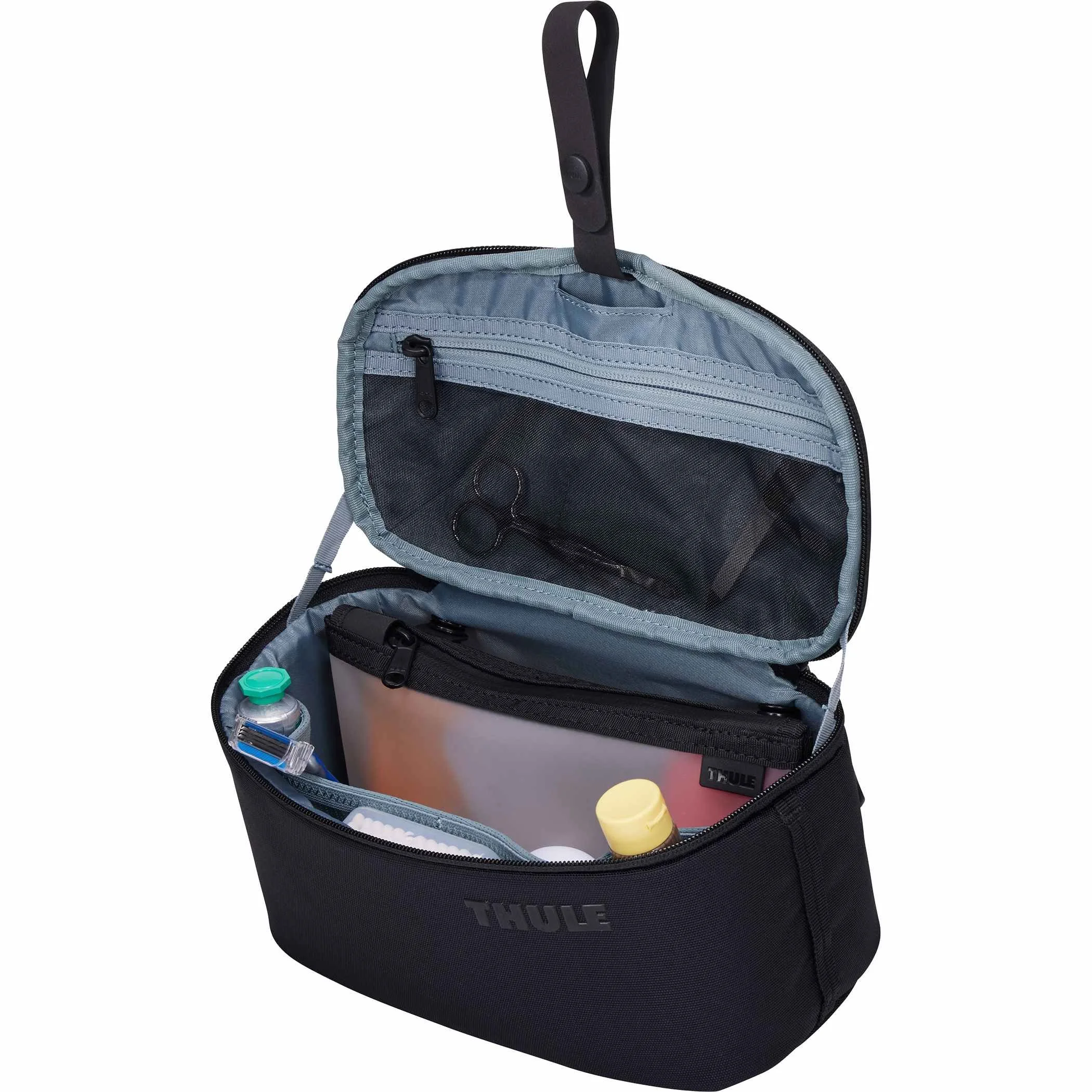 Thule Subterra 2 toiletry bag hanging by its loop, open with toiletries inside