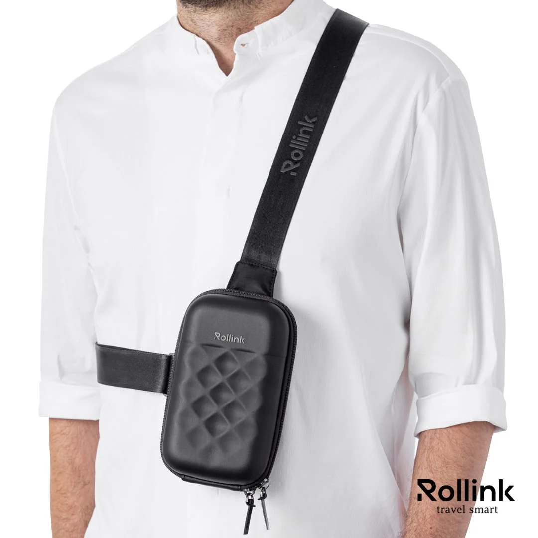 Person wearing a Rollink Mini Bag Go hard shell sling bag crossbody over a white shirt