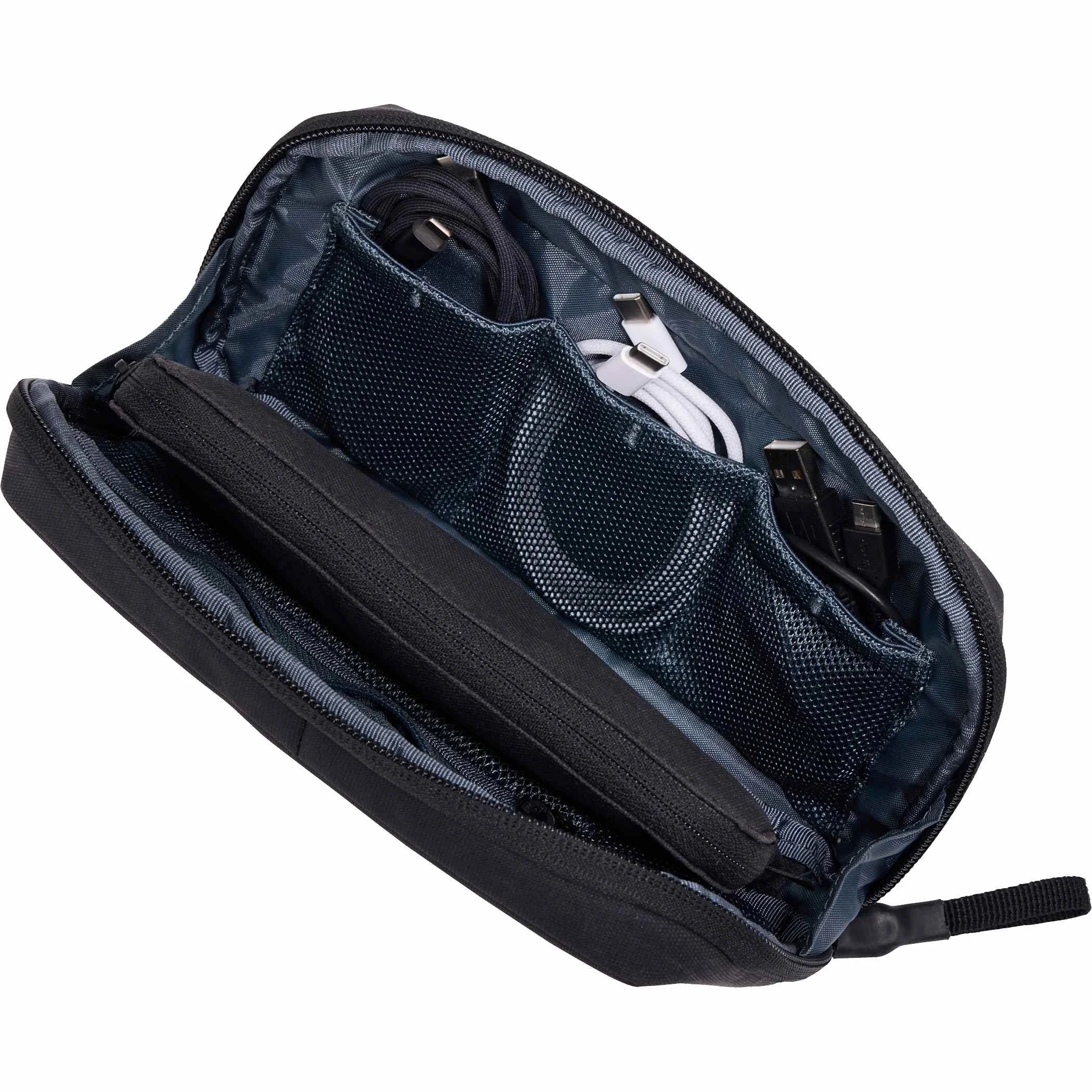 Open Thule Aion travel organizer holding earbuds, chargers and cables