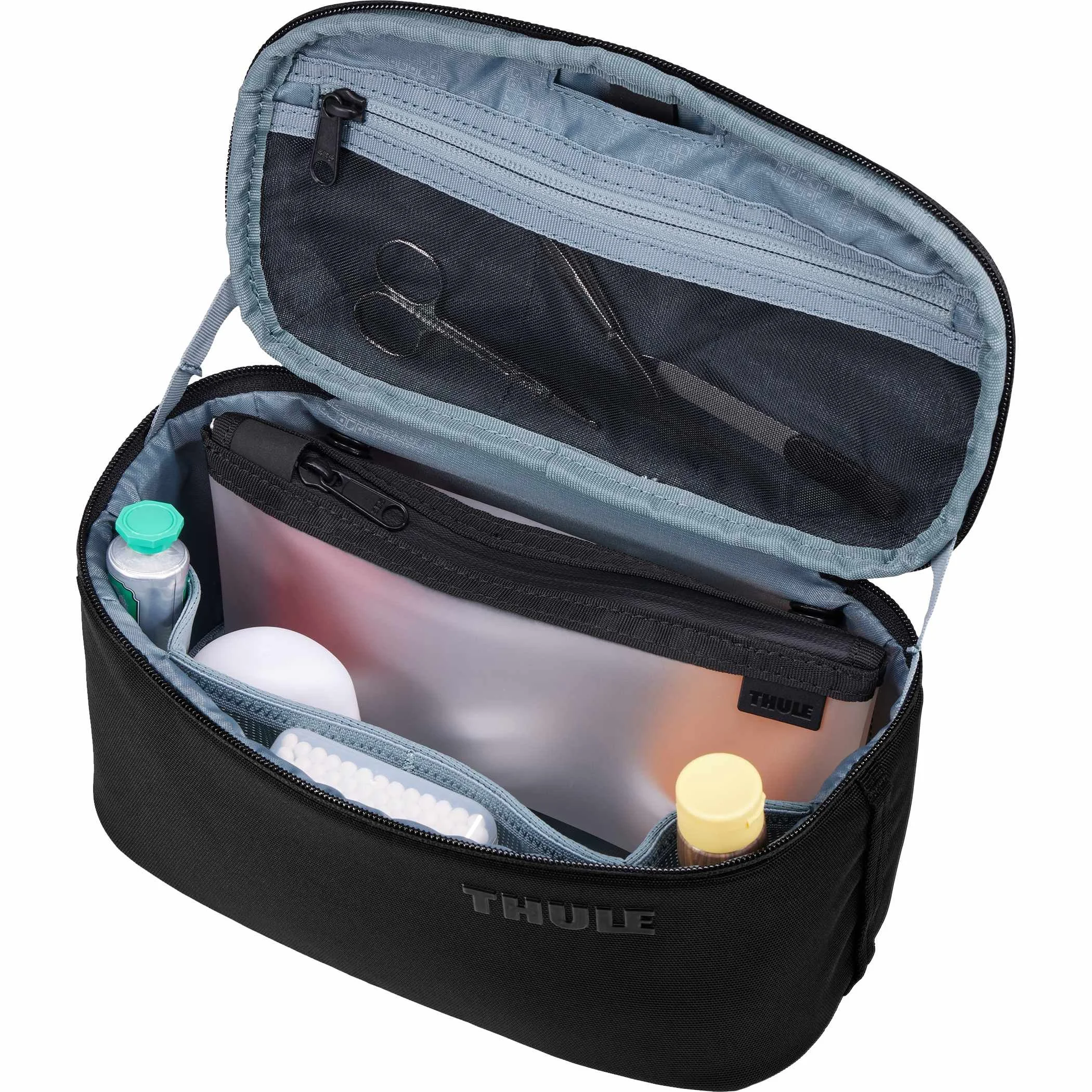 Thule Subterra 2 toiletry bag open and packed with bottles and a clear zippered pouch