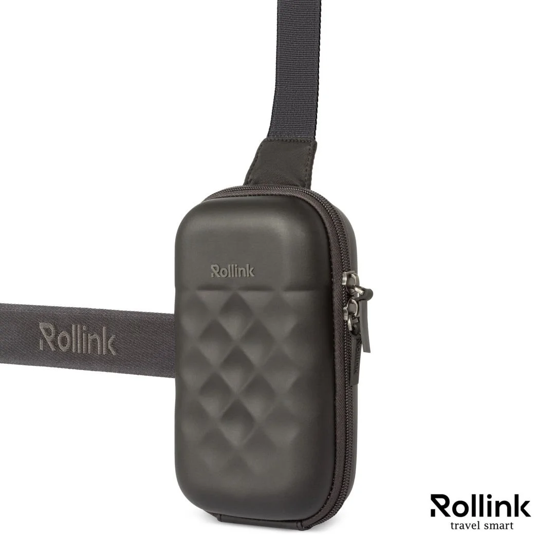 Dark gray Rollink Mini Bag Go hard shell sling bag shown from the side with strap