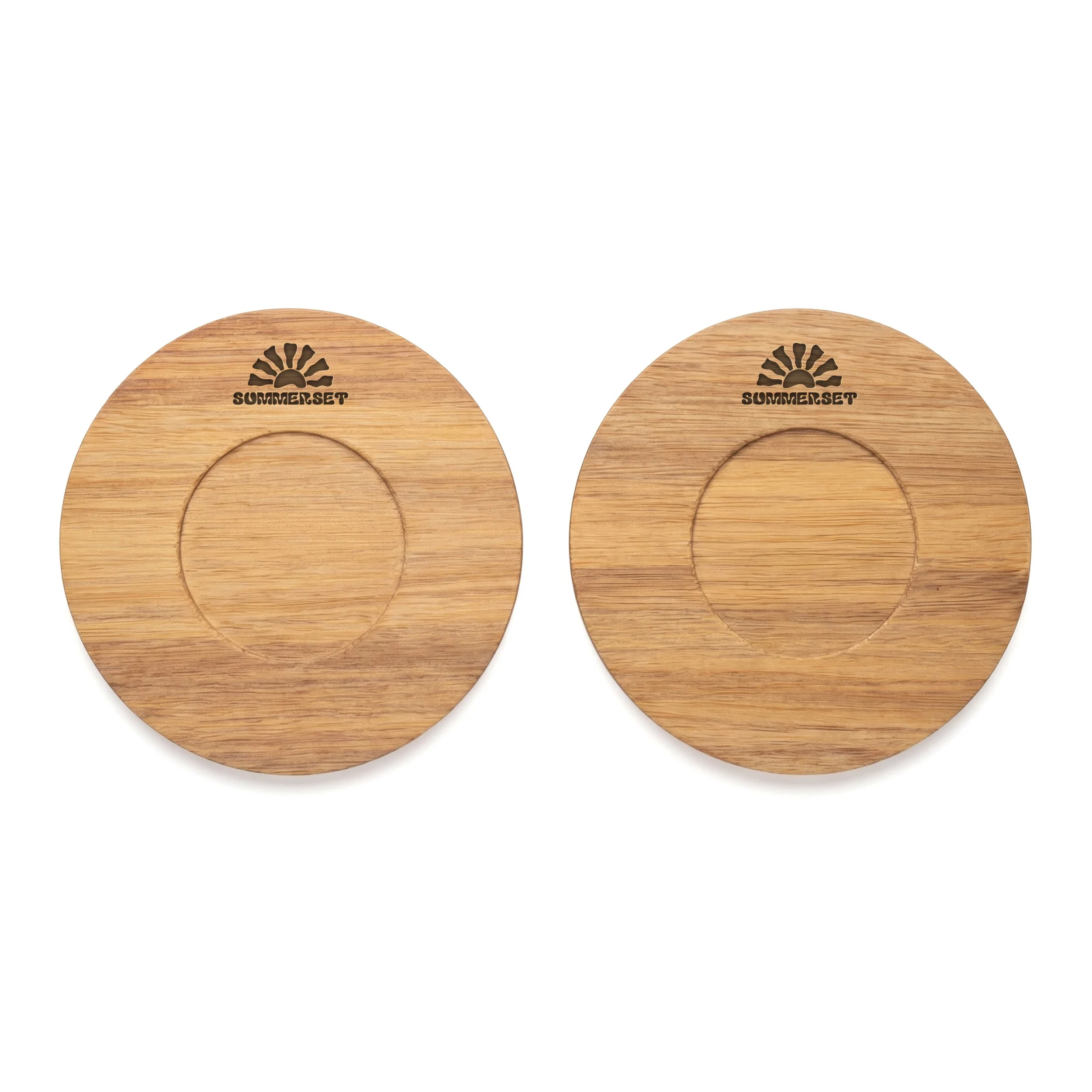 Same two acacia wood coasters engraved with a sample sun-and-arch logo, showing how a Canadian client's mark would appear.