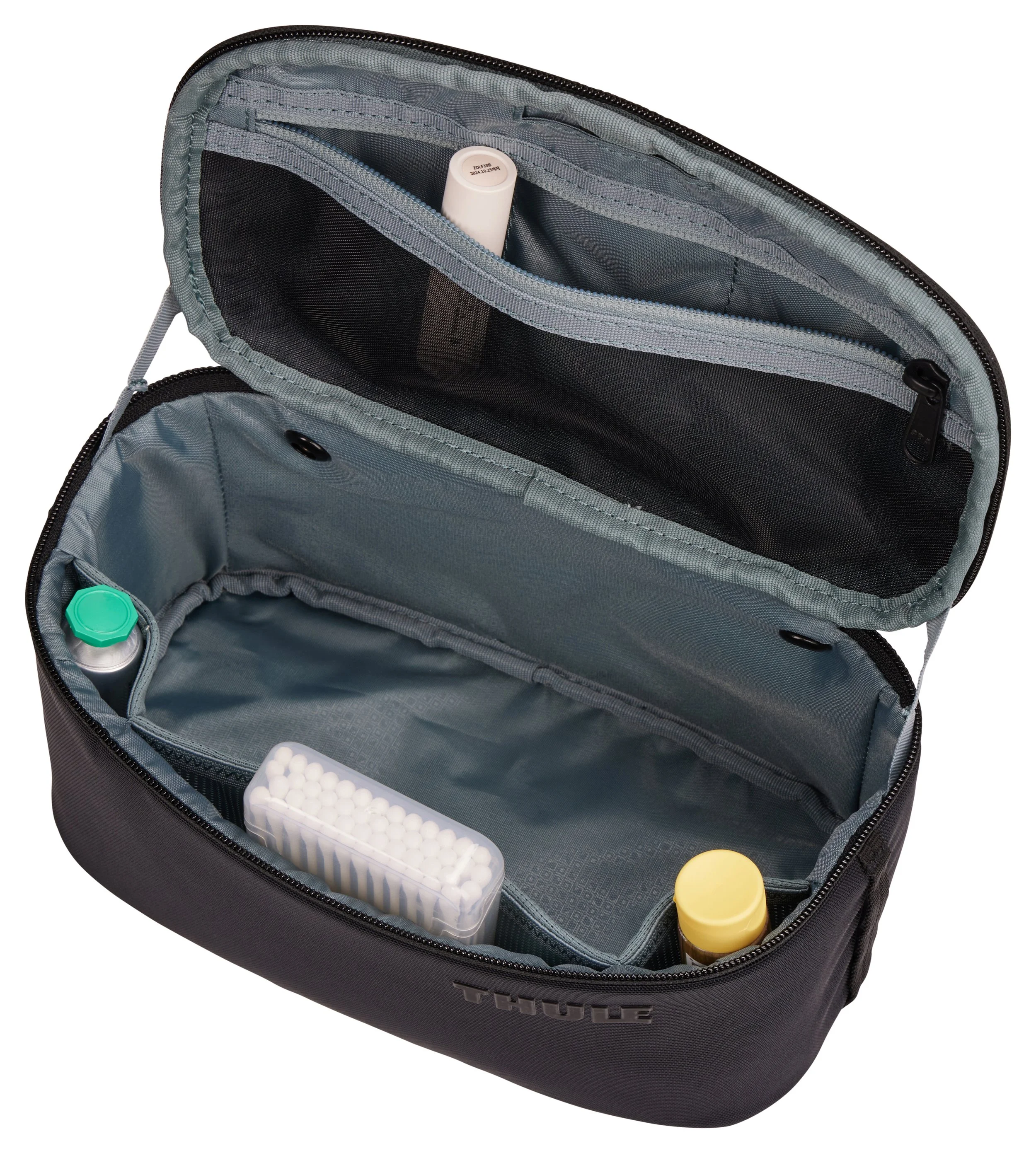 Open Thule Subterra 2 toiletry bag with mesh lid pocket and toiletries visible inside