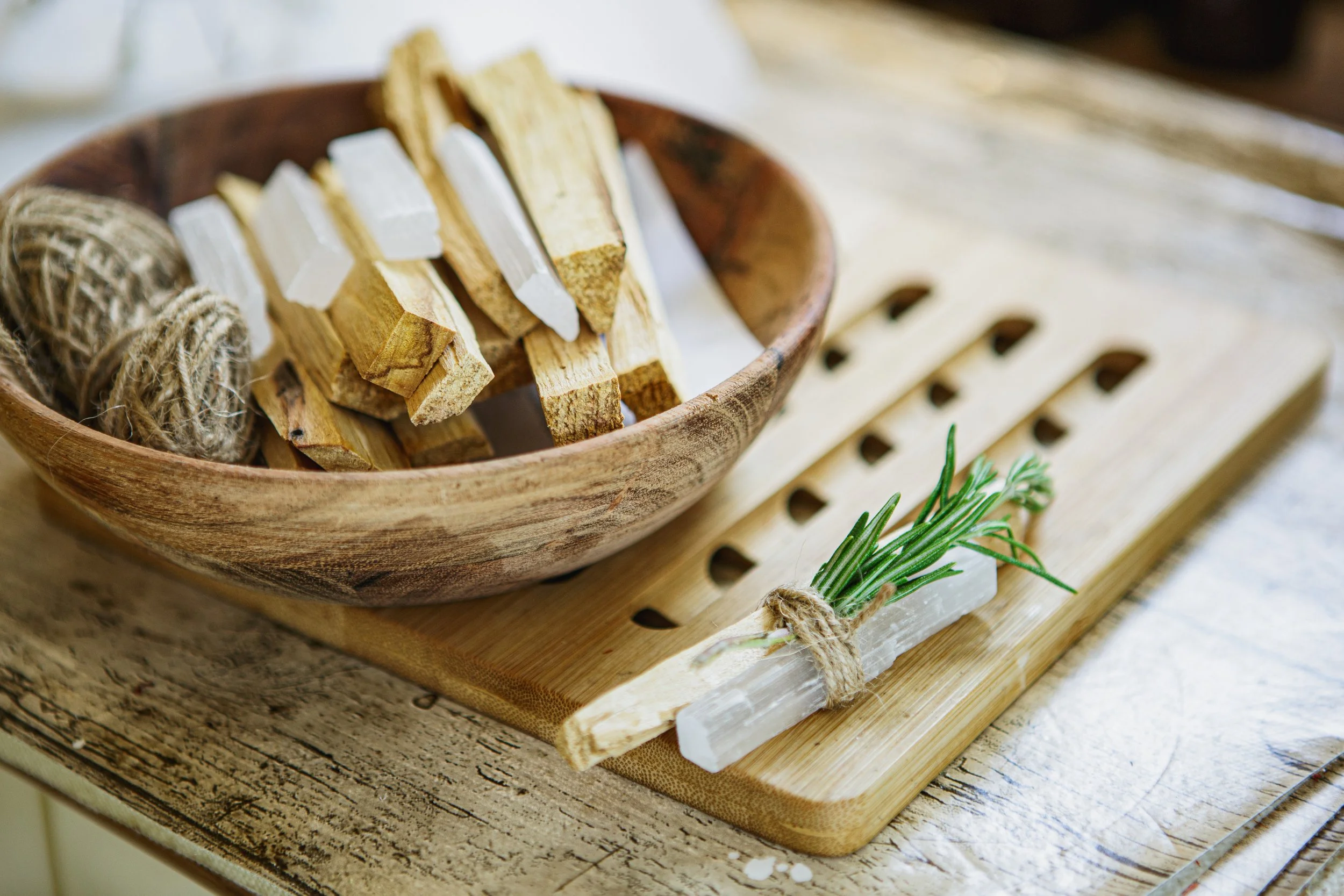 Handmade botanical products arranged on the left of a horizontal wooden tabletop, leaving open space on the right.