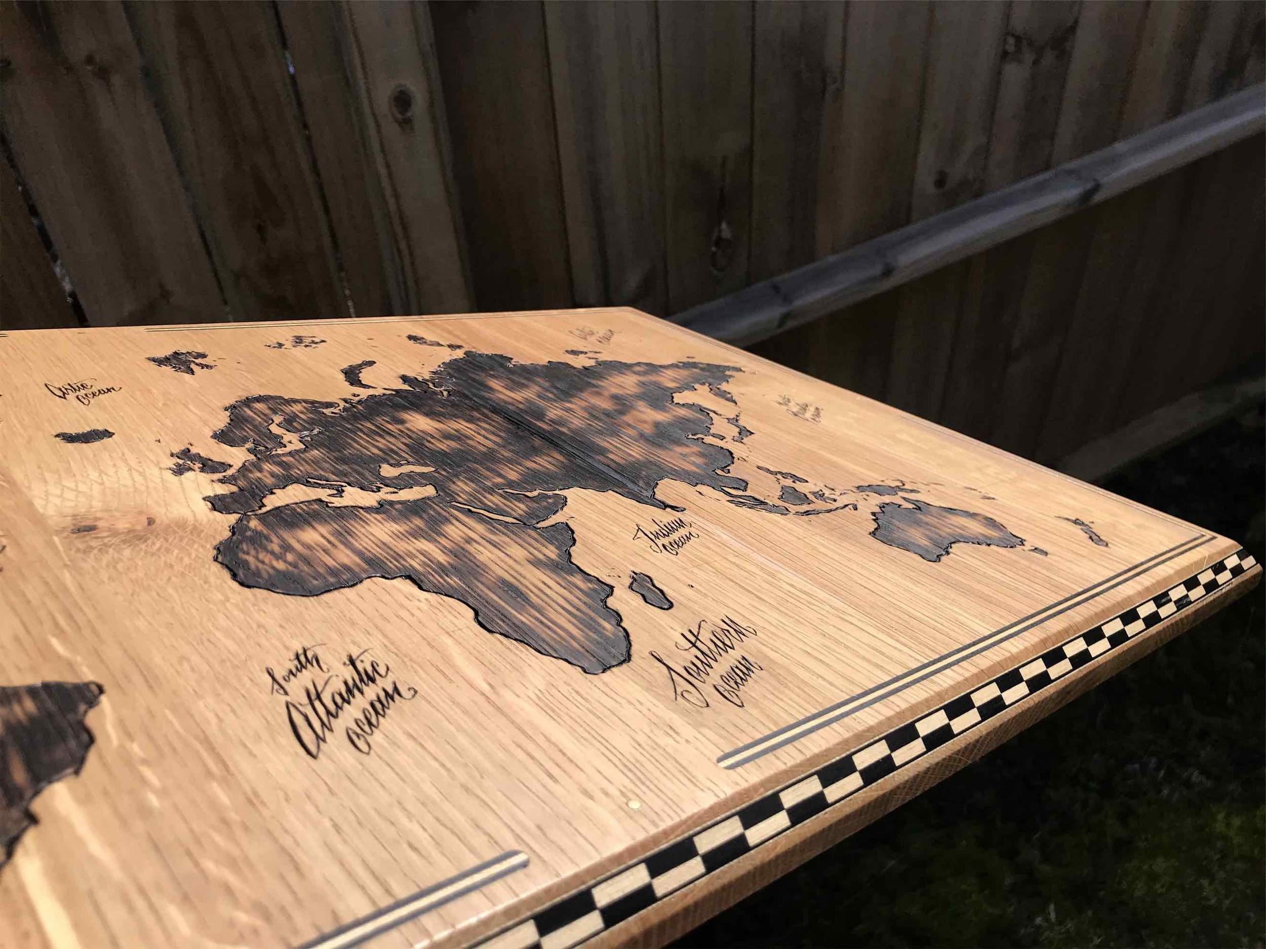 wood burned map with calligraphy.jpg