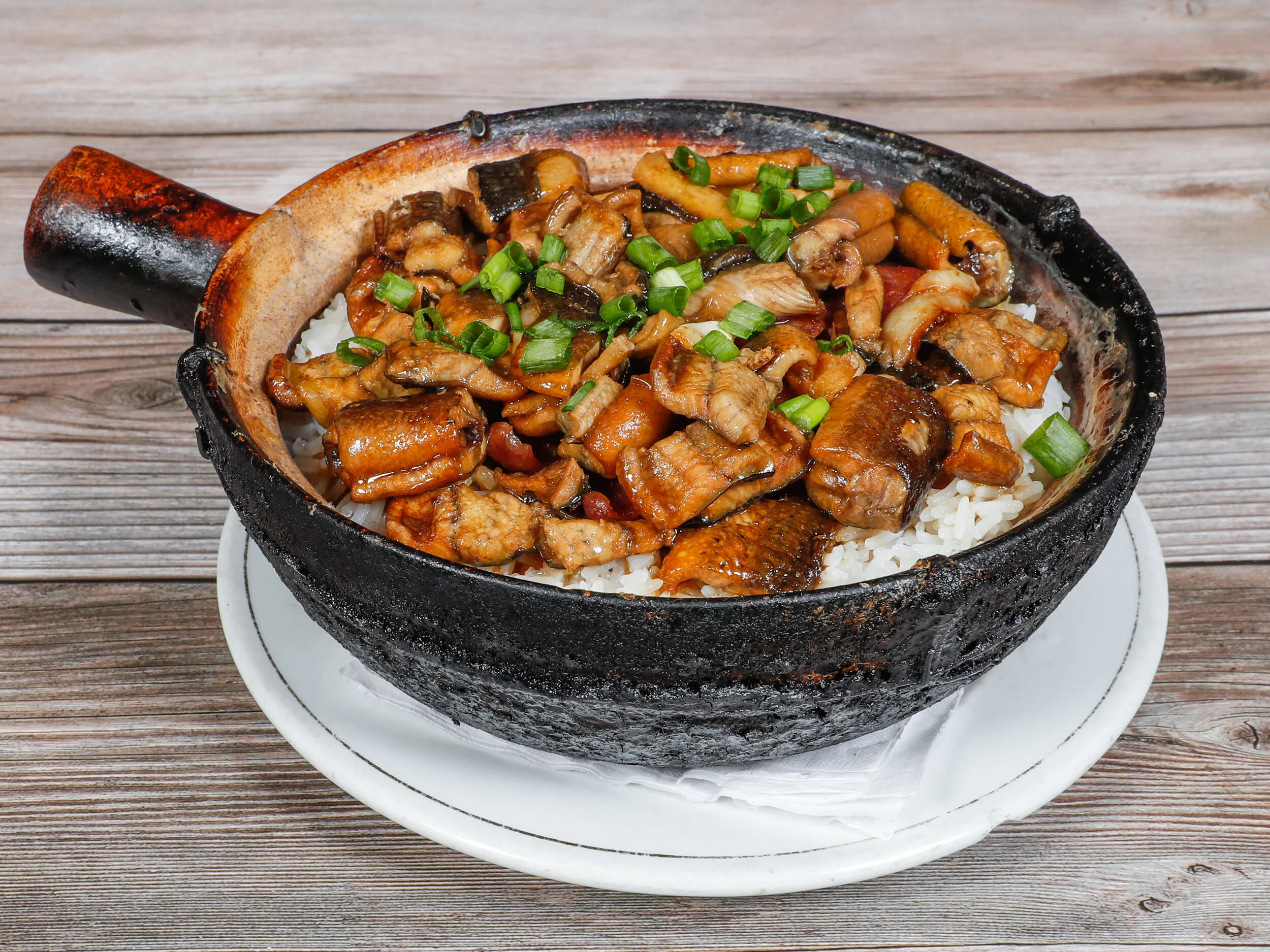 Taishan yellow eel clay pot rice topped with scallions at Clay Pot House in San Francisco