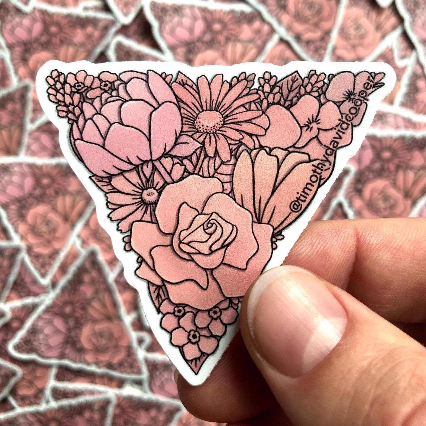 An inverted pink triangle, but make it flowers. 🌸🔻🌷 

The pink triangle has dark origins as a symbol, but Queer people know exactly how much power there is to be found in reclaiming what was once used as a tool for oppression. One of my favorite t