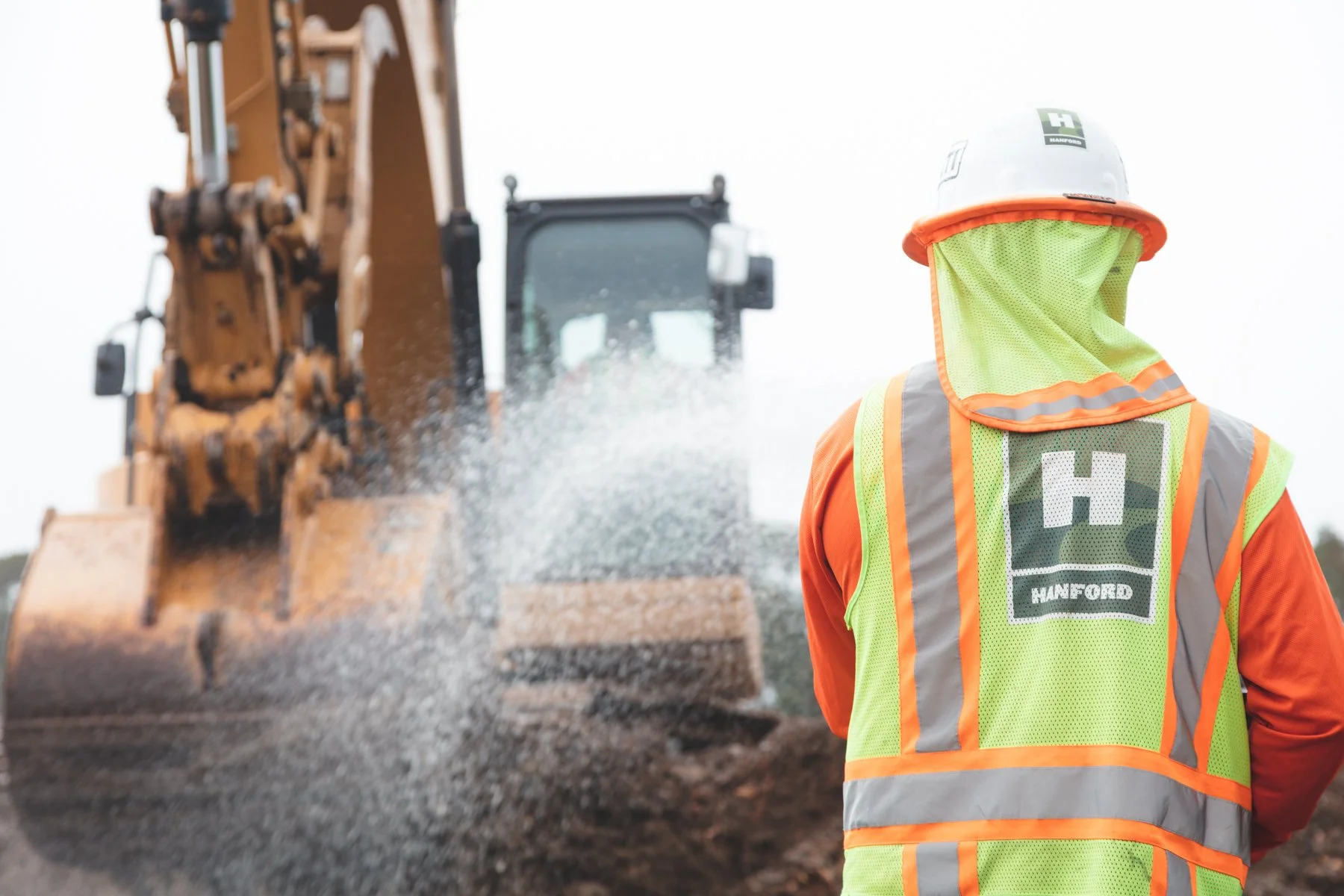Worker spraying hose at equipment