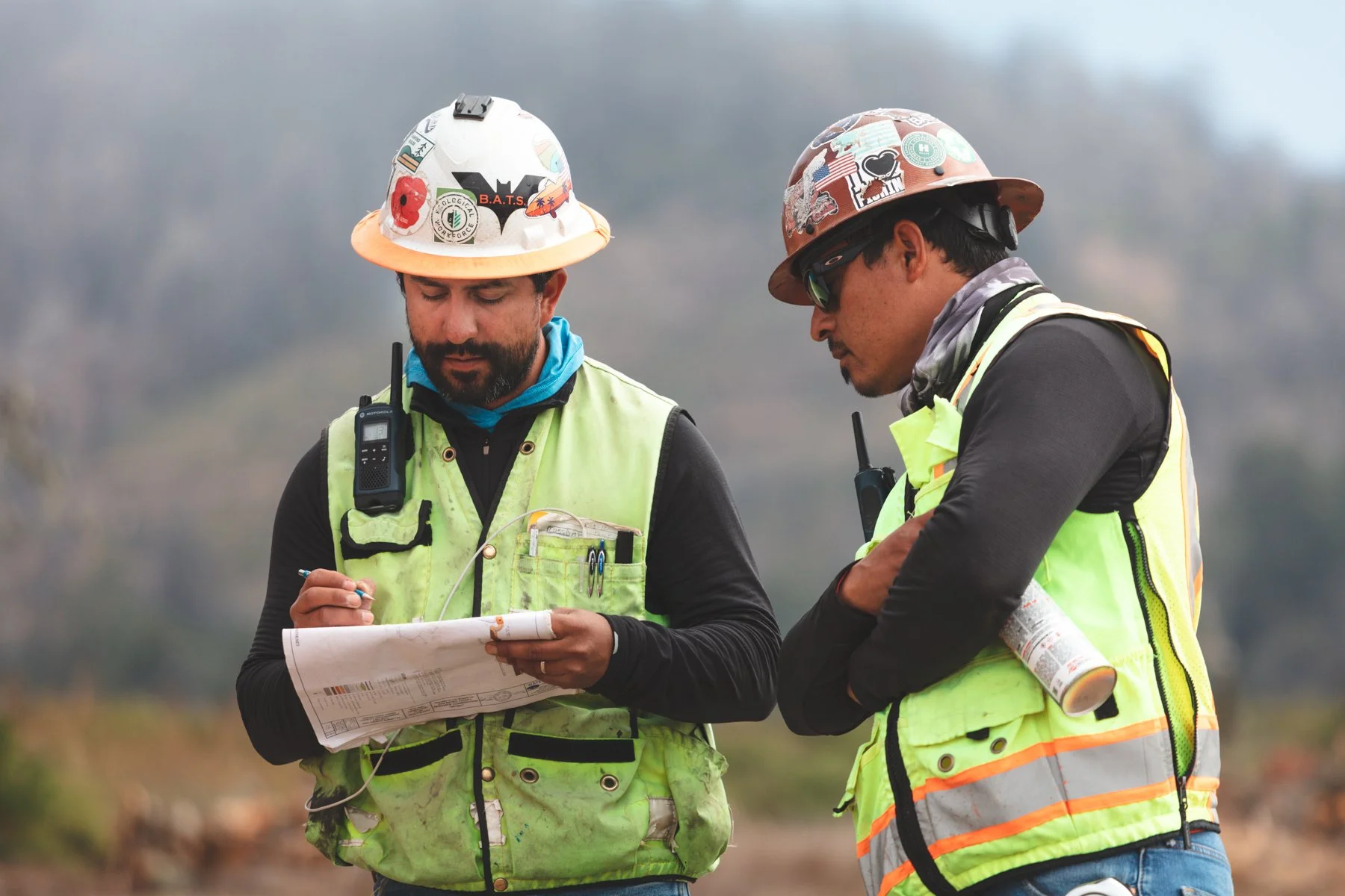 two team members looking over plans