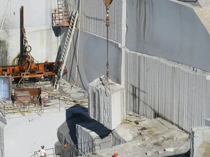 Crane lifting a 40 ton granite block in a quarry