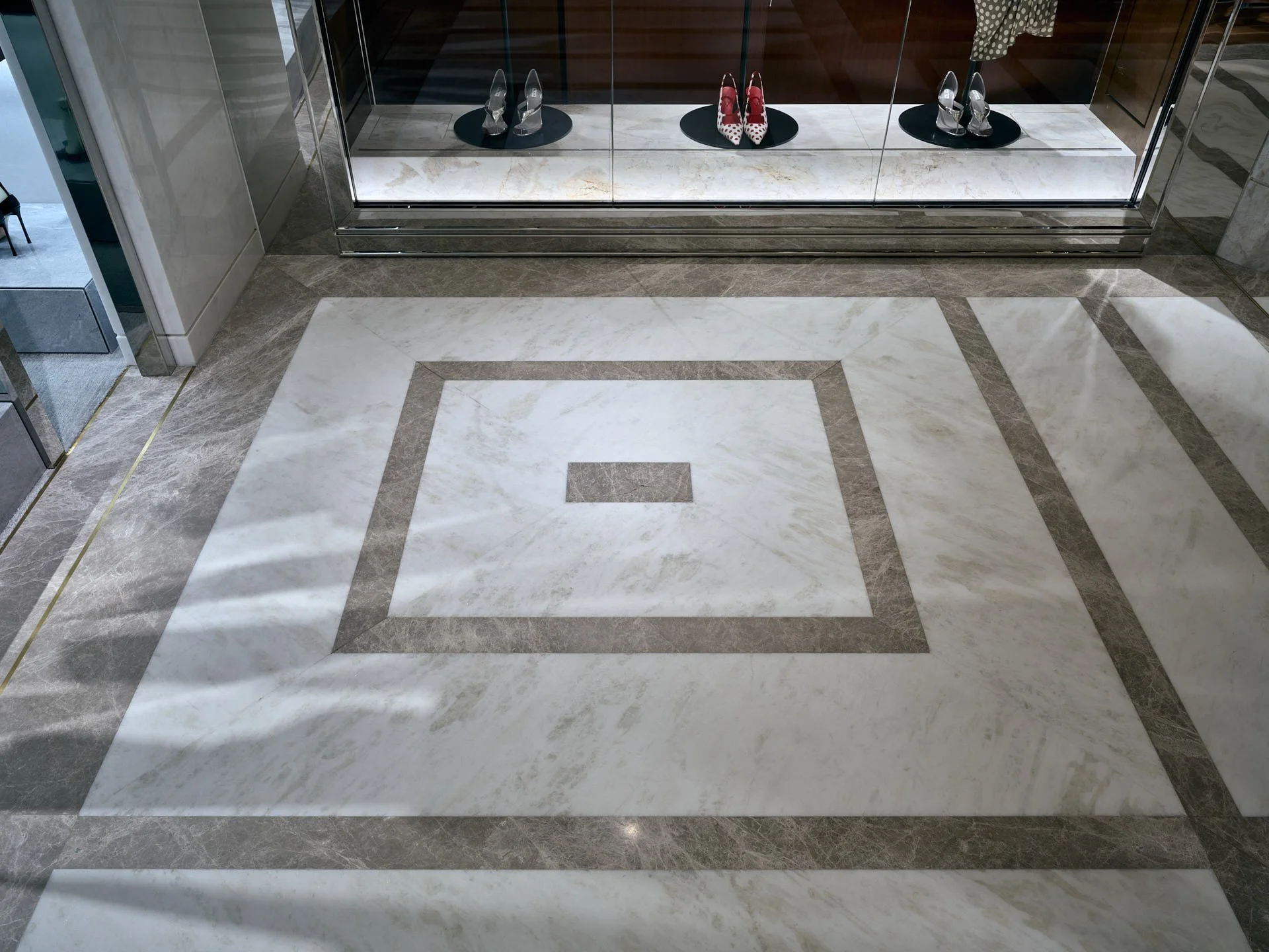 Square geometric floor motif in pale Namibian White marble with contrasting grey marble bands by stoneCIRCLE - photo Marco Joe Fazio STUDIO