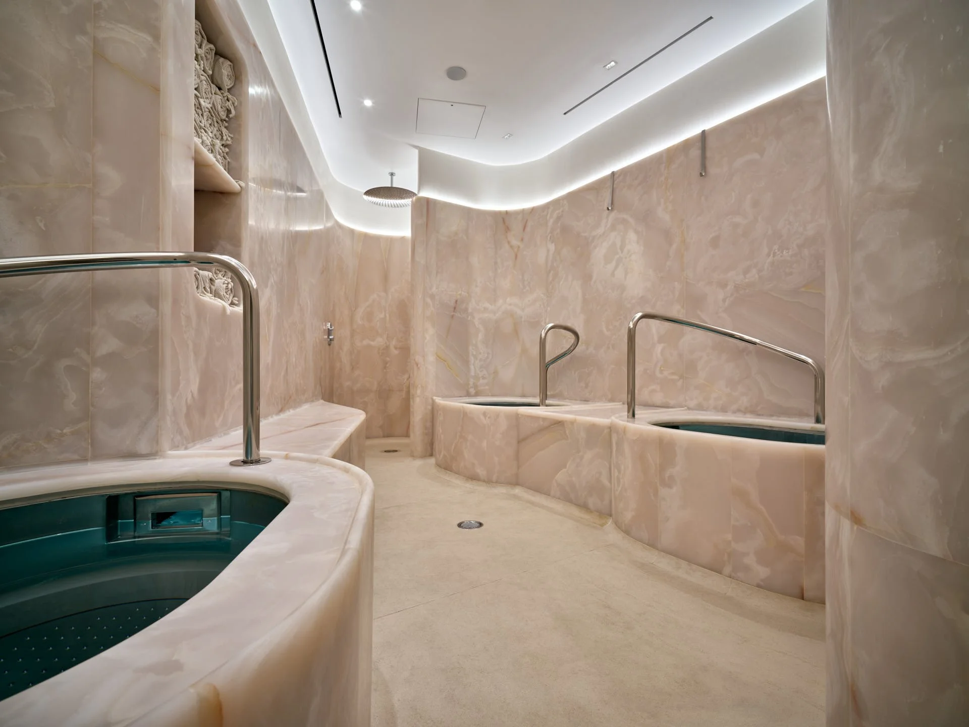 Curved Rose Onyx creates an immersive setting around The Method’s contrast-therapy baths by stoneCIRCLE - photo Marco Joe Fazio Studio