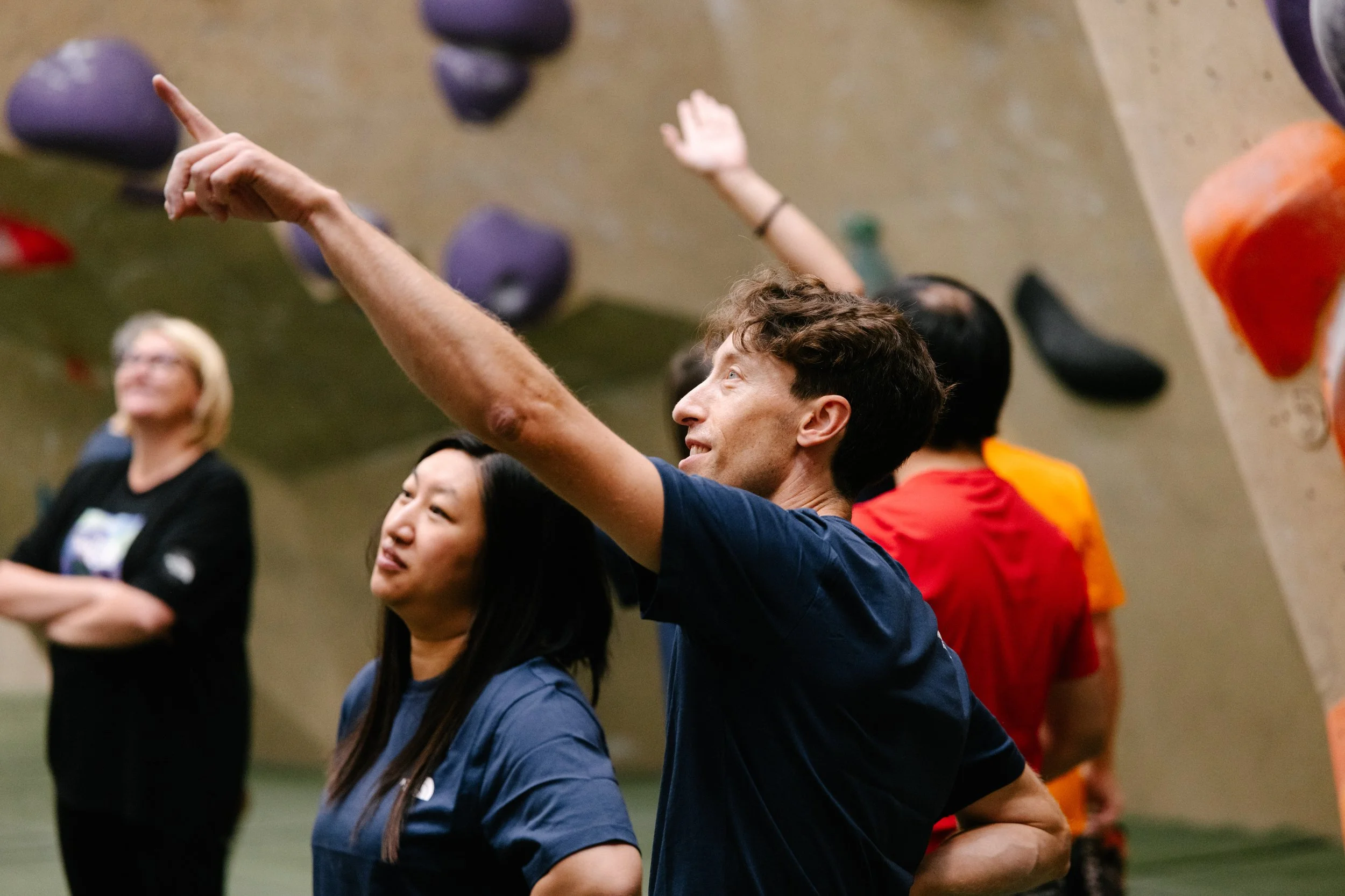 Young man and Women looking at boulders