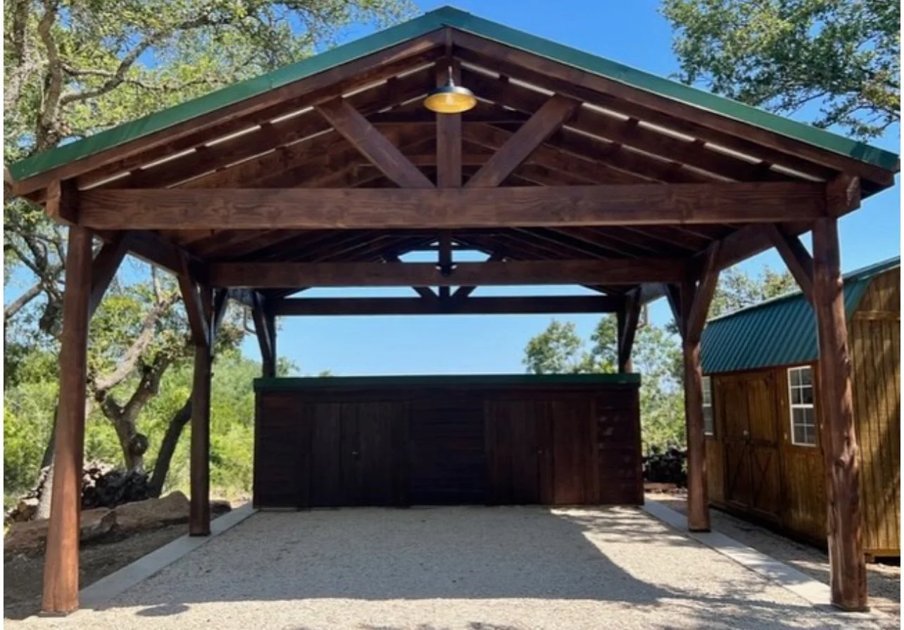 Front view of a timber carport with exposed gable framing.