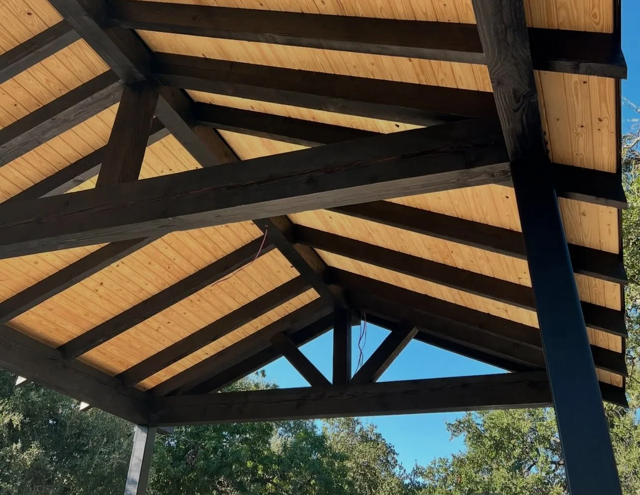 Exposed timber trusses beneath a pitched roof.