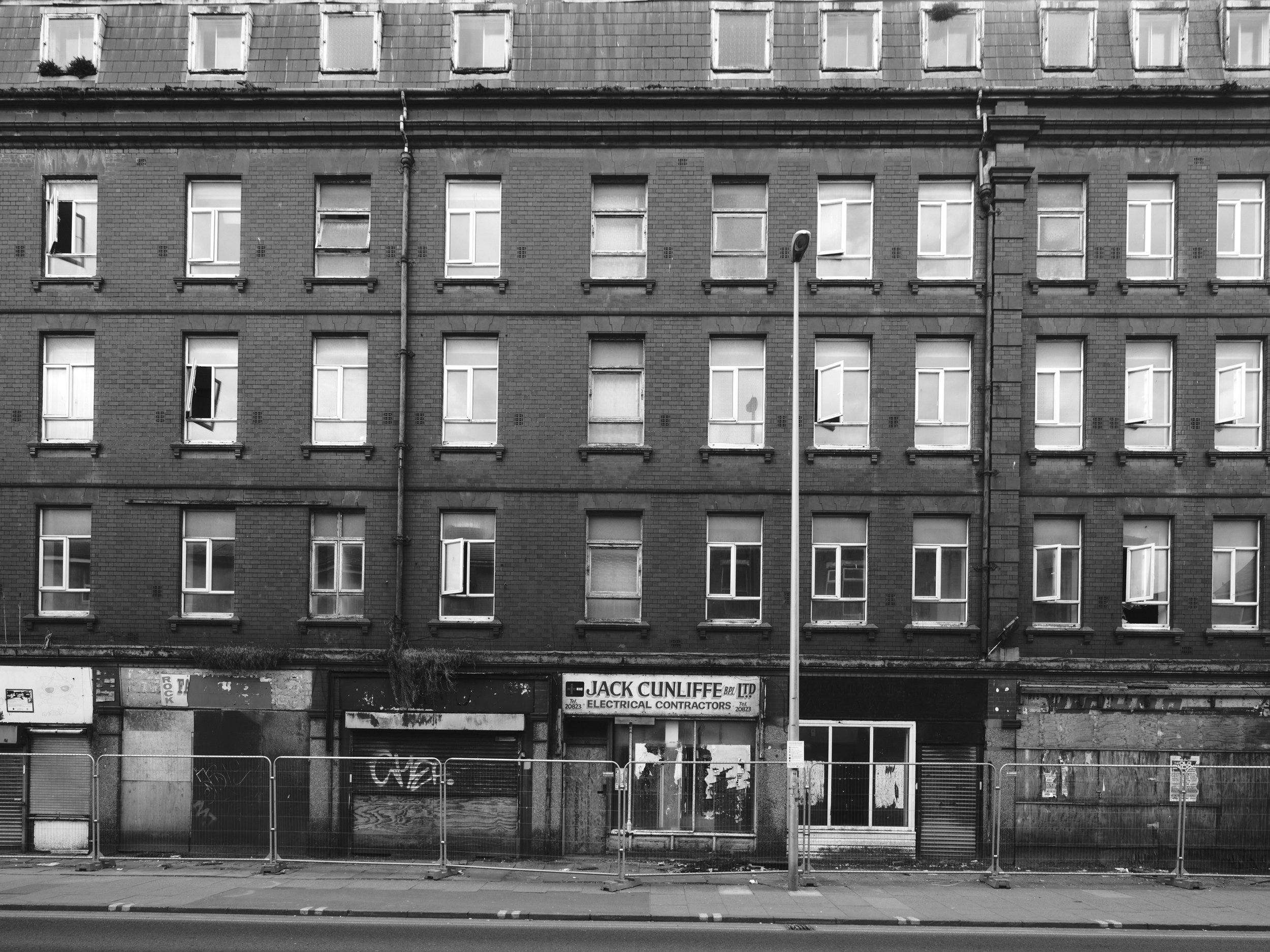 Cheap flats above abandoned shops.