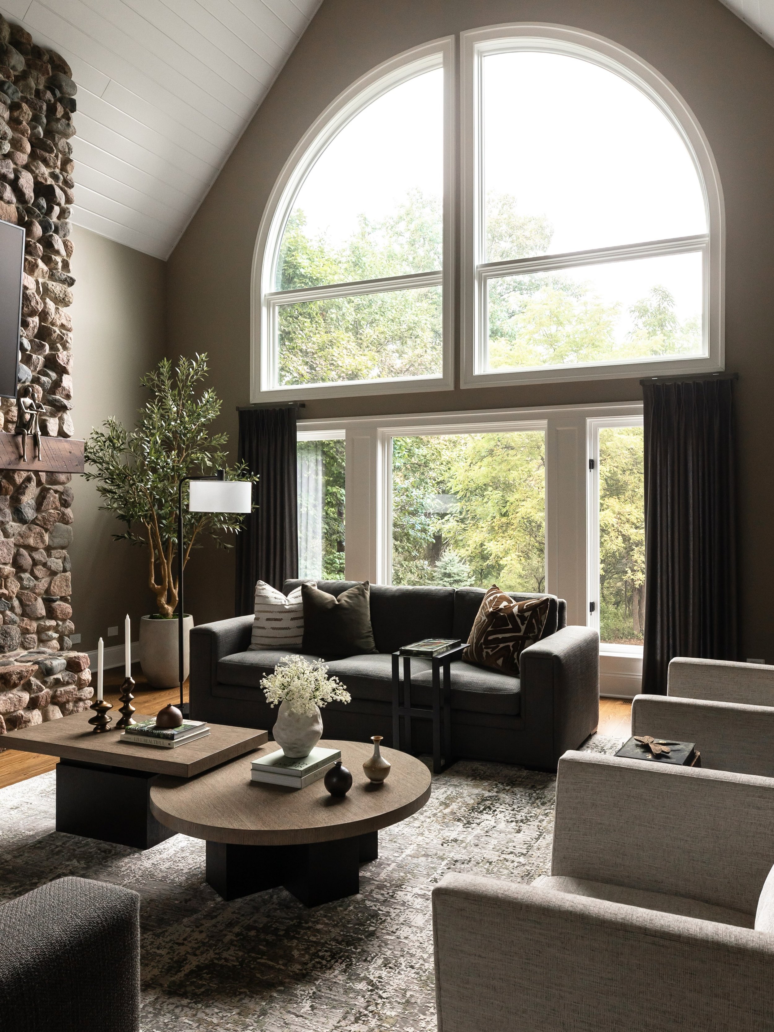 When we started this project, we knew the architecture and scenery needed to be part of the design. Between the vaulted ceilings, the oversized arched windows, and the views of the surrounding trees, we wanted to create a space that felt connected to