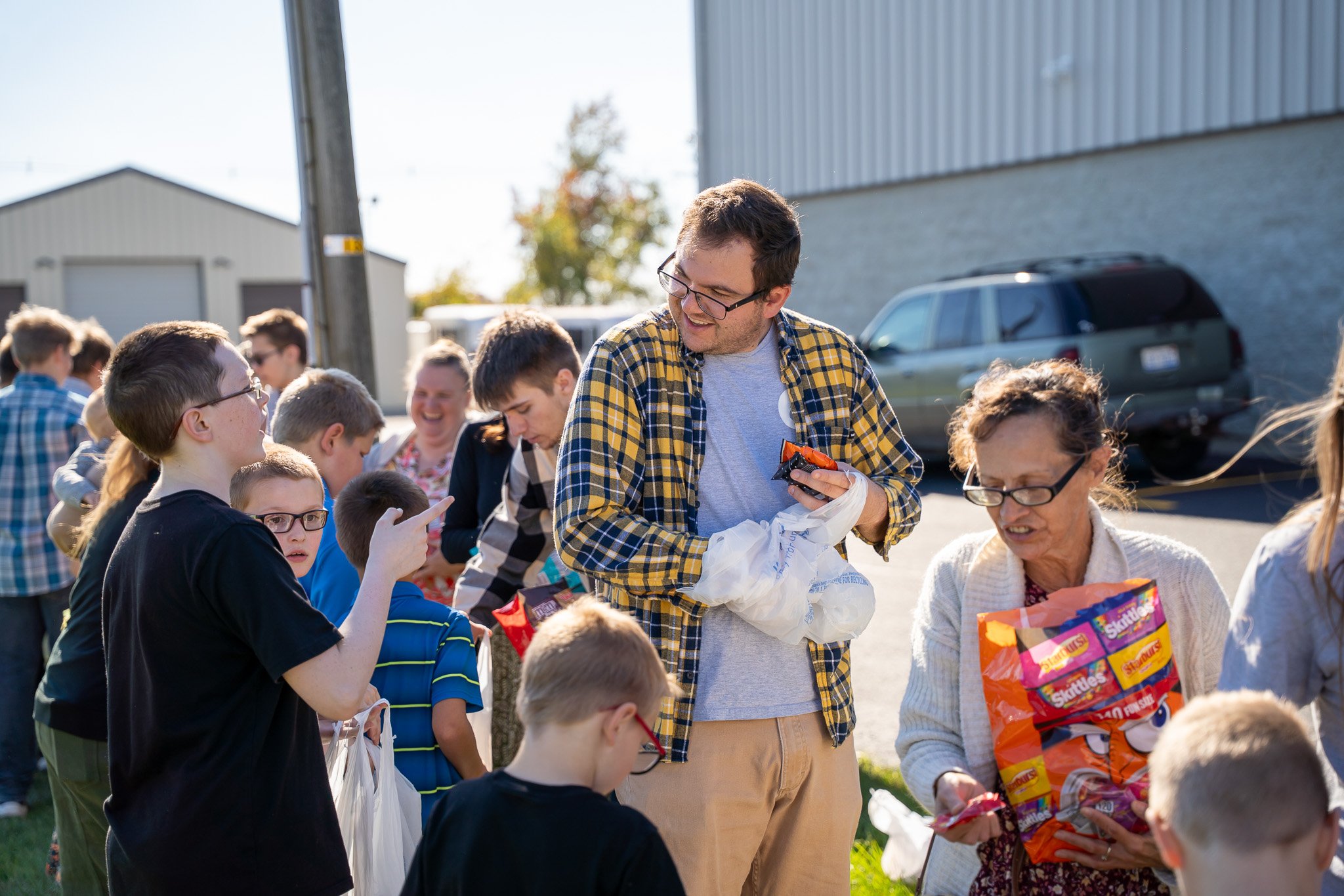 Person holding an open Bible with tabs, wearing a checkered shirt.