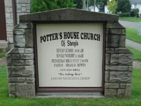Sign for Potter's House Church of Sturgis, displaying service times and pastor's name.