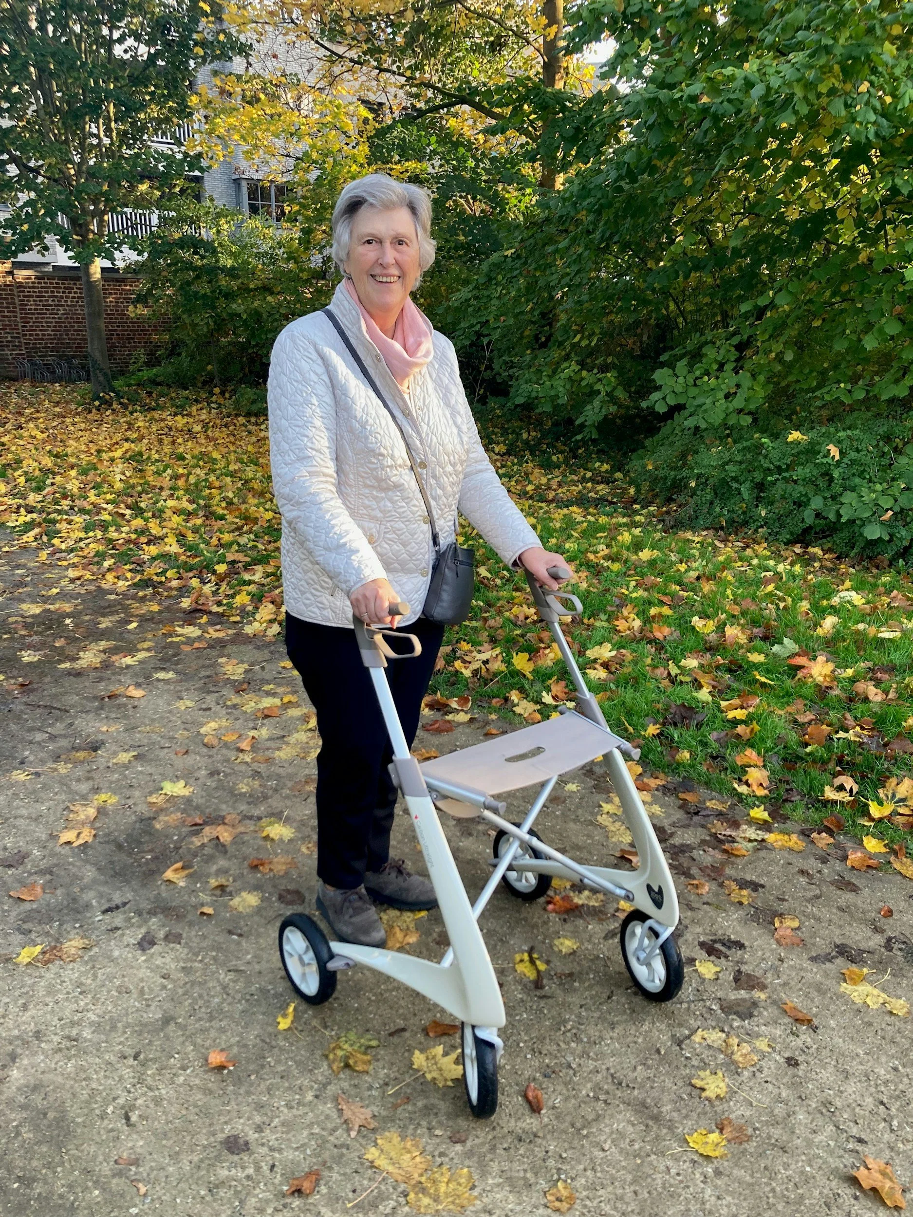 Woman walking outdoors with walker. Mobility support, walking rehabilitation, walker training Port Elgin. Senior chiropractor Port Elgin. Bruce Village Chiropractic.