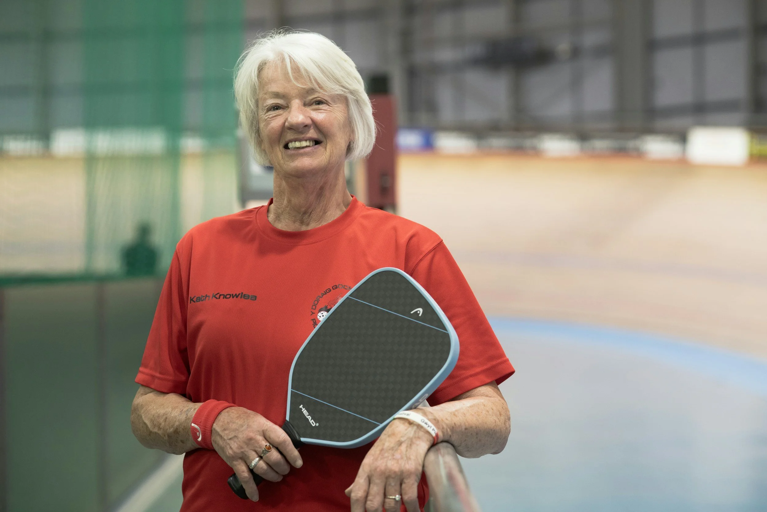 Senior woman smiling and playing pickleball. Pickleball injury relief chiropractor Port Elgin Bruce Village Chiropractic