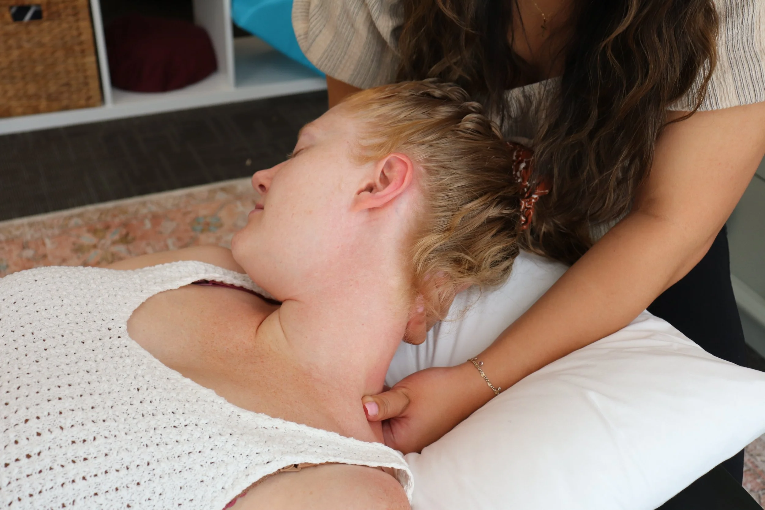 Port Elgin Chiropractors Dr. Tuason and Dr. Burns are pictured. Dr. Tuason is offering manual muscle release to Dr. Burns to relieve muscle tension and pain.