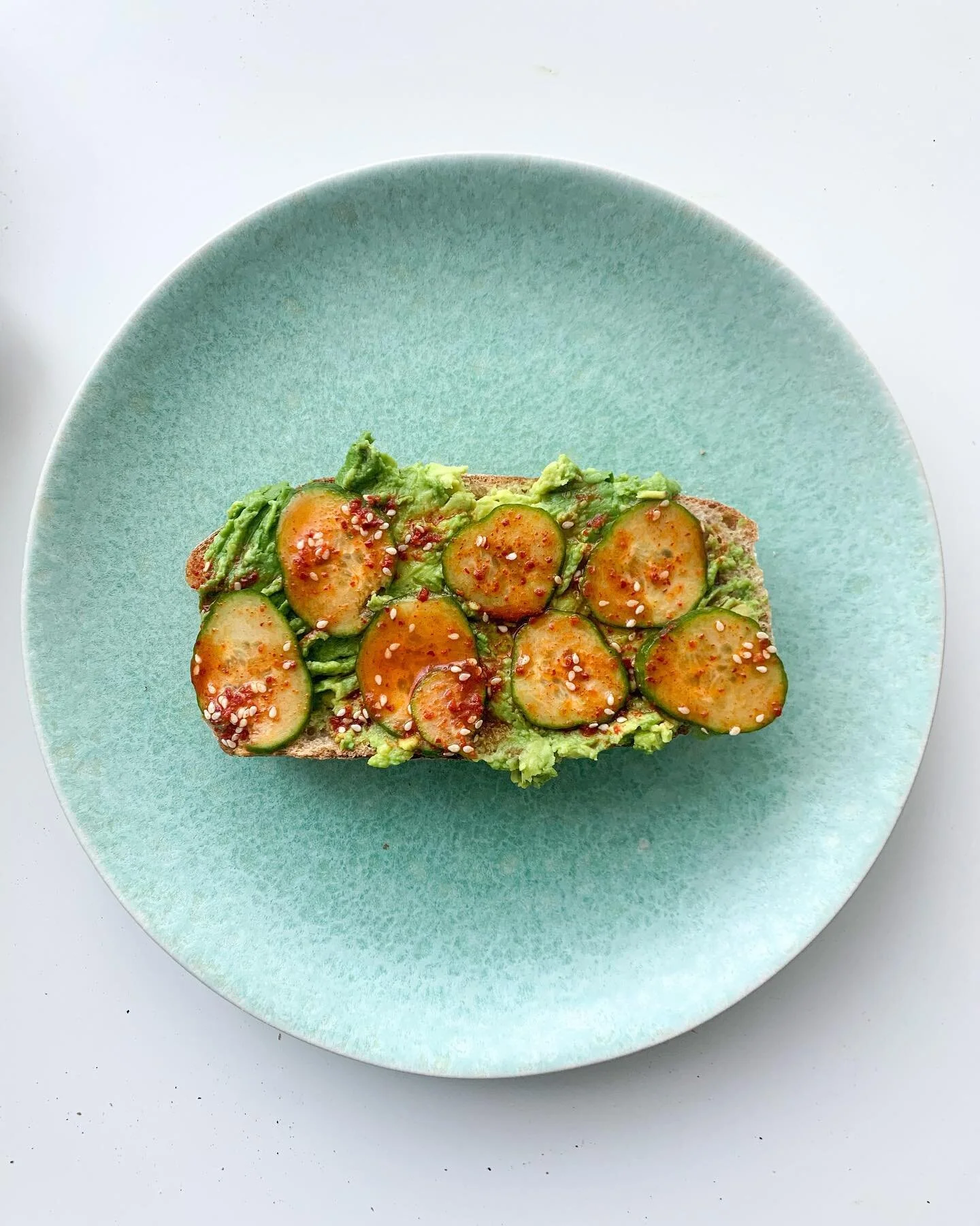 Because regular avocado toast is ~so~ 2013. Toasted sourdough from @breadbakeryto topped with avocado and a Korean-inspired pickled cucumber salad (gochugaru, cucumber, sesame oil, rice vinegar, sesame seeds, salt, soy sauce).