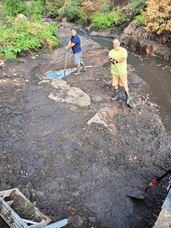 Picture of the BWWD Weir shows Izzy and Brian digging and redirecting the water flow