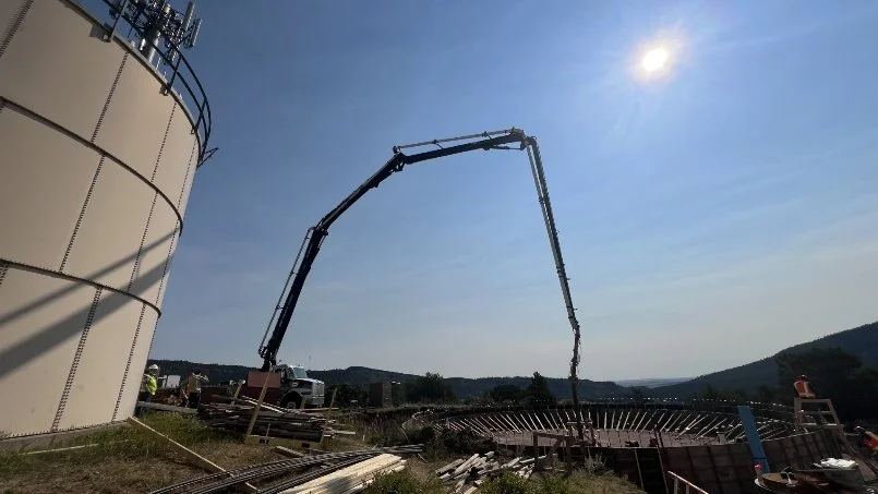 Pouring cement for the foundation of the new tank