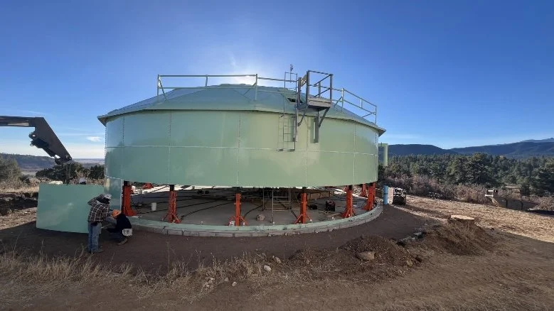 The new tank rises, top constructed first, then each subsequent layer added by jacking up the completed segments and assembling beneath