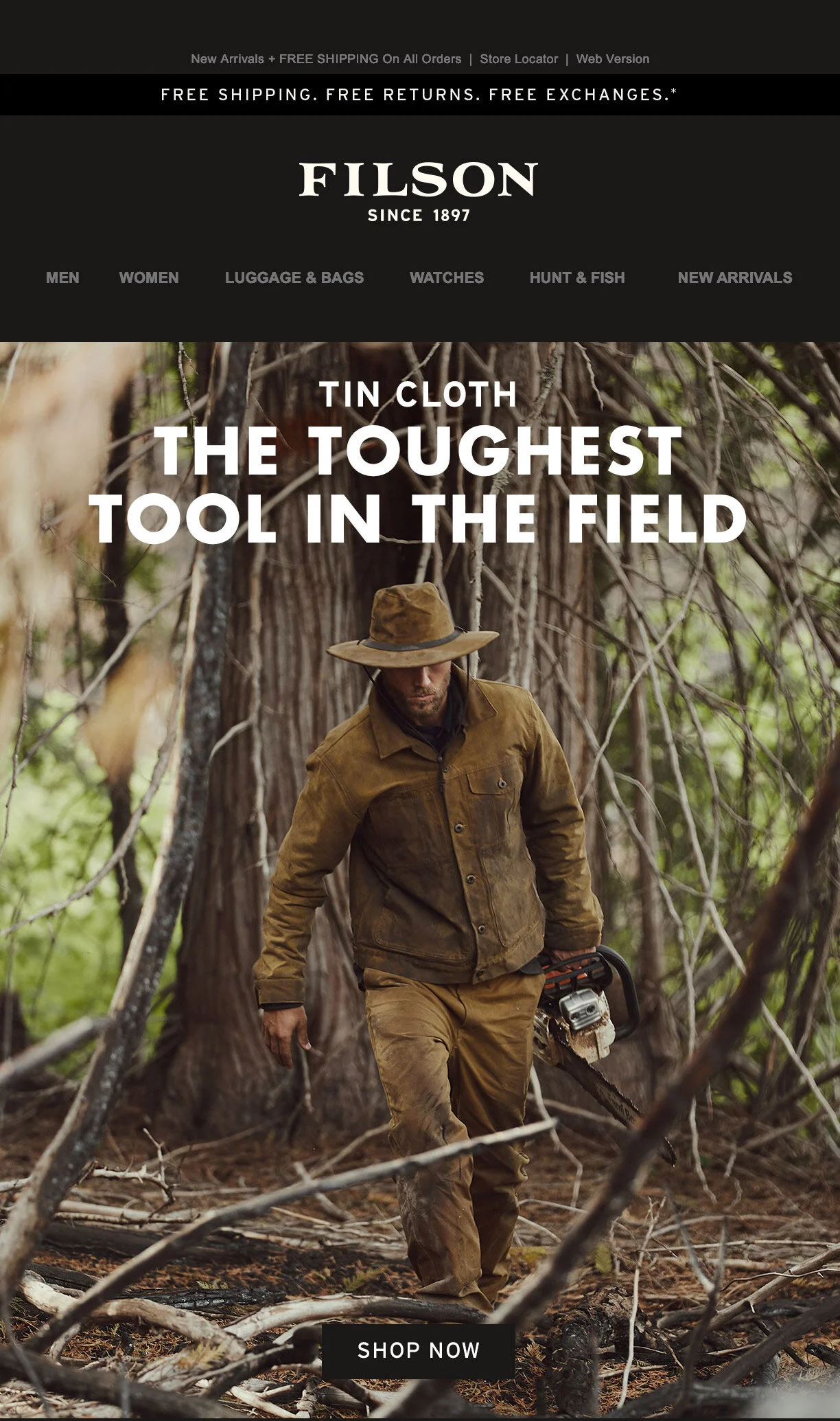 a man wearin a tin cloth hat, jacket and pants carrying a chainsaw in the woods